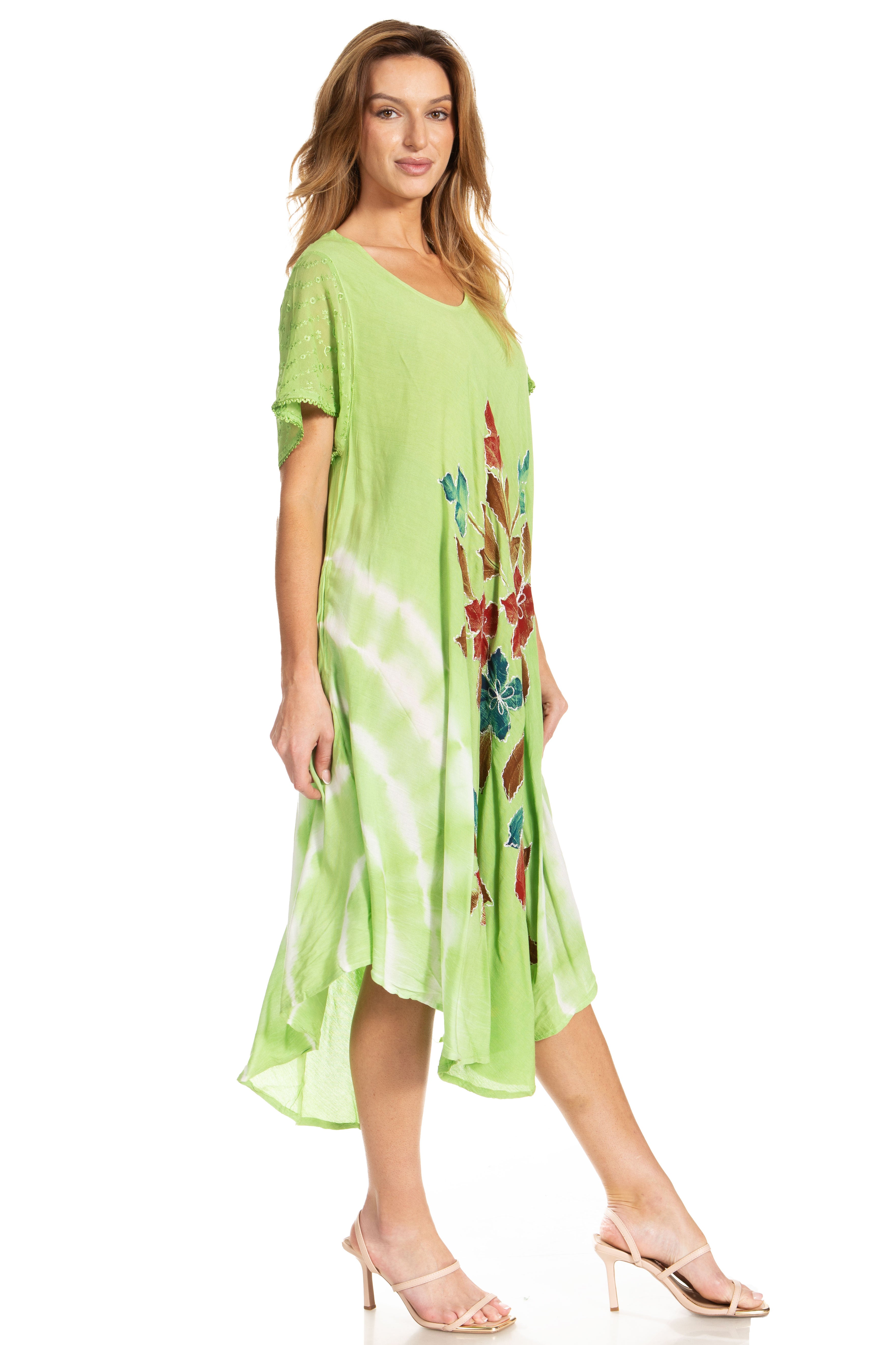 Woman wearing a green dress with floral patterns on a white background