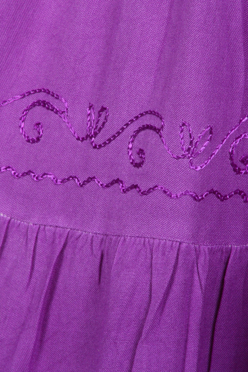 Close-up of purple fabric with decorative stitching