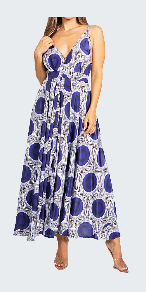 Woman wearing a sleeveless dress with a blue and white pattern on a white background