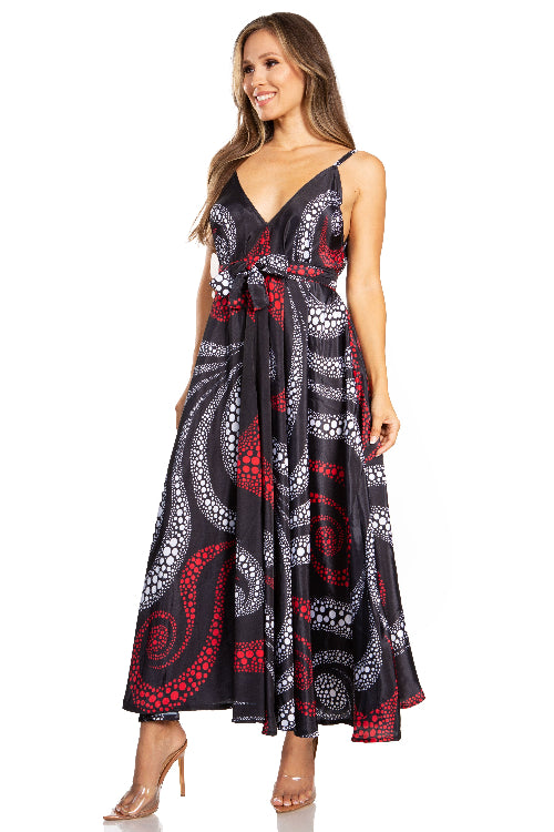 Woman wearing a sleeveless dress with a black, red, and white pattern on a white background