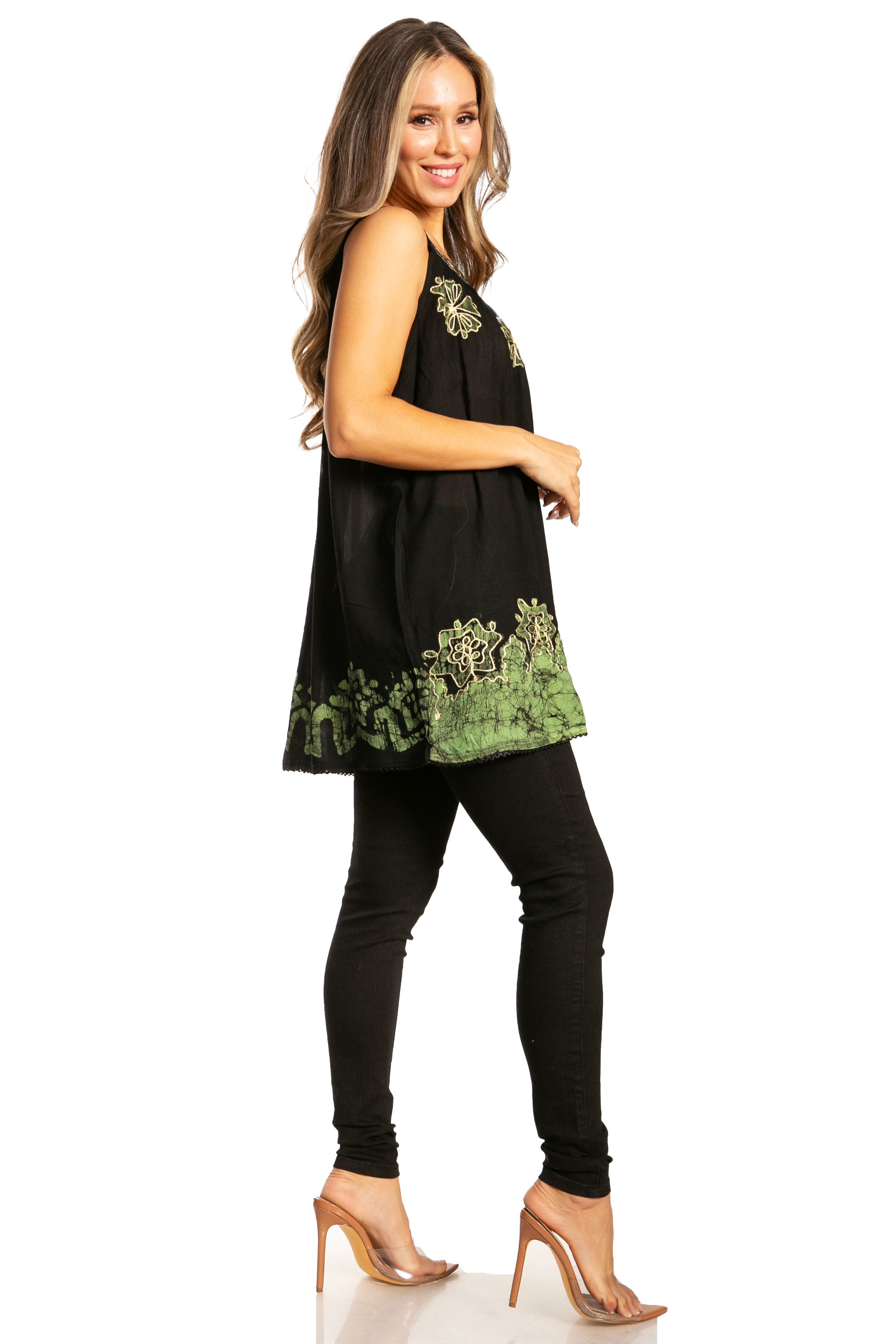 Woman wearing a black dress with green embroidery on a white background