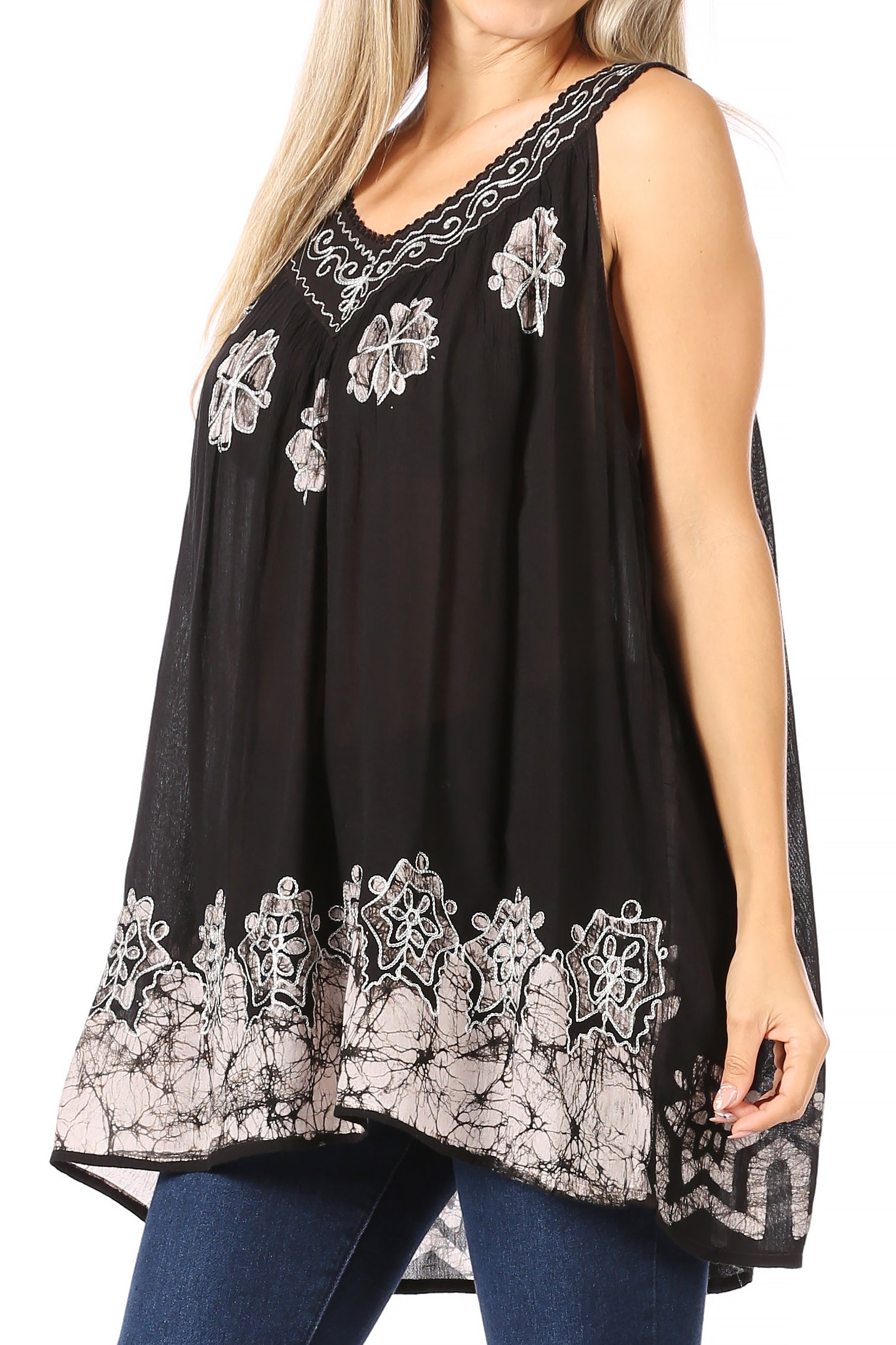 Black sleeveless top with white lace embroidery worn by a person