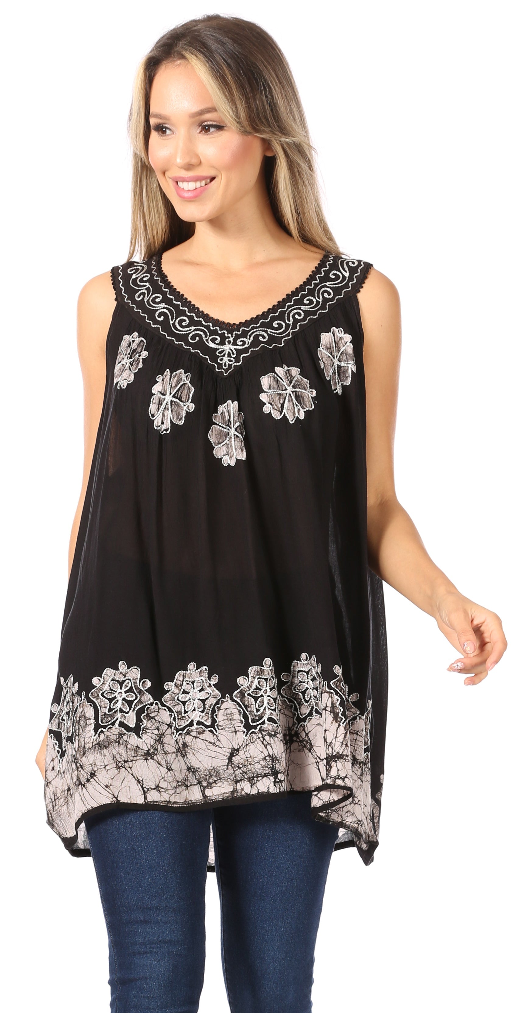 Woman wearing a black sleeveless top with white floral embroidery on a white background