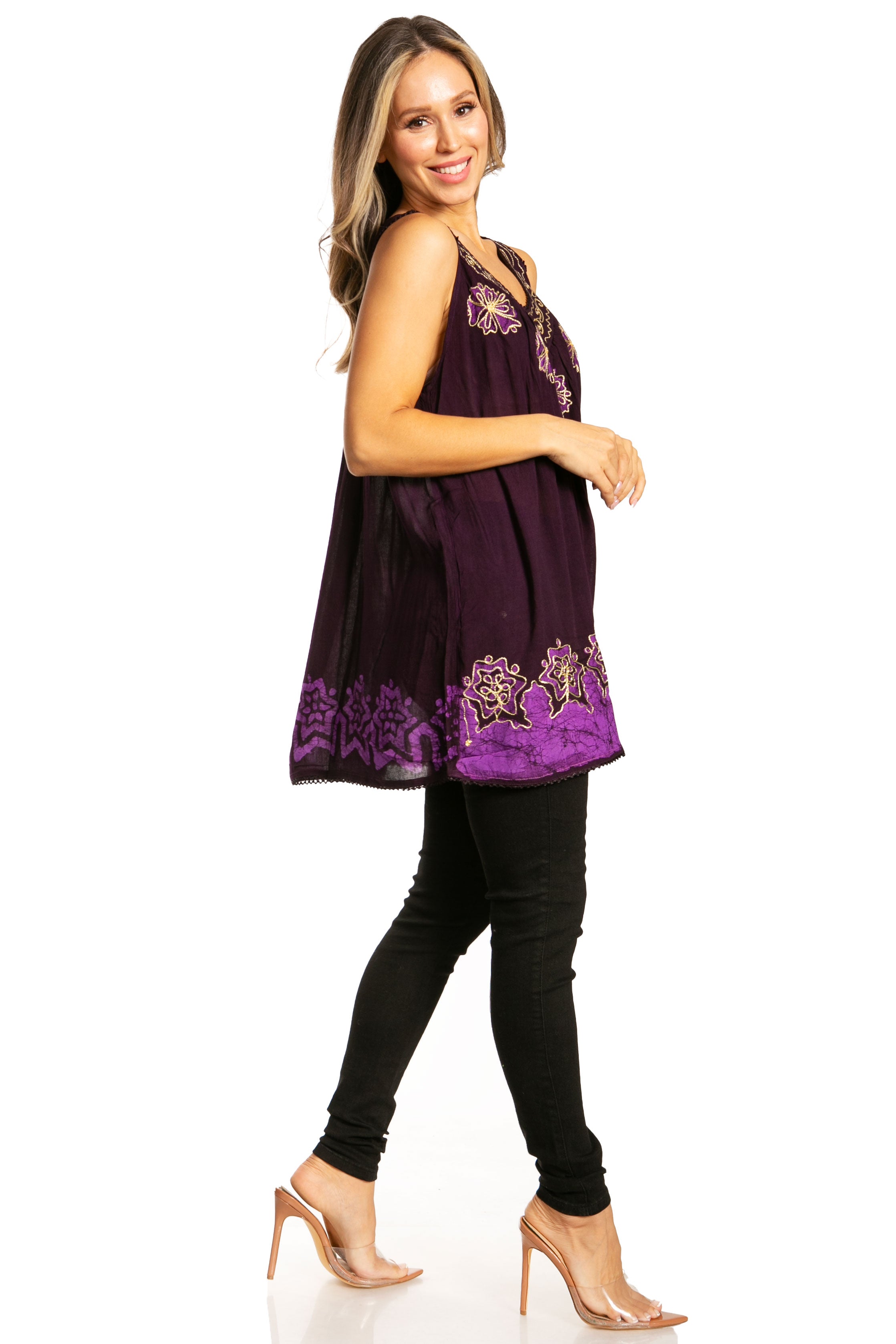 Woman wearing a purple sleeveless top with floral embroidery on a white background