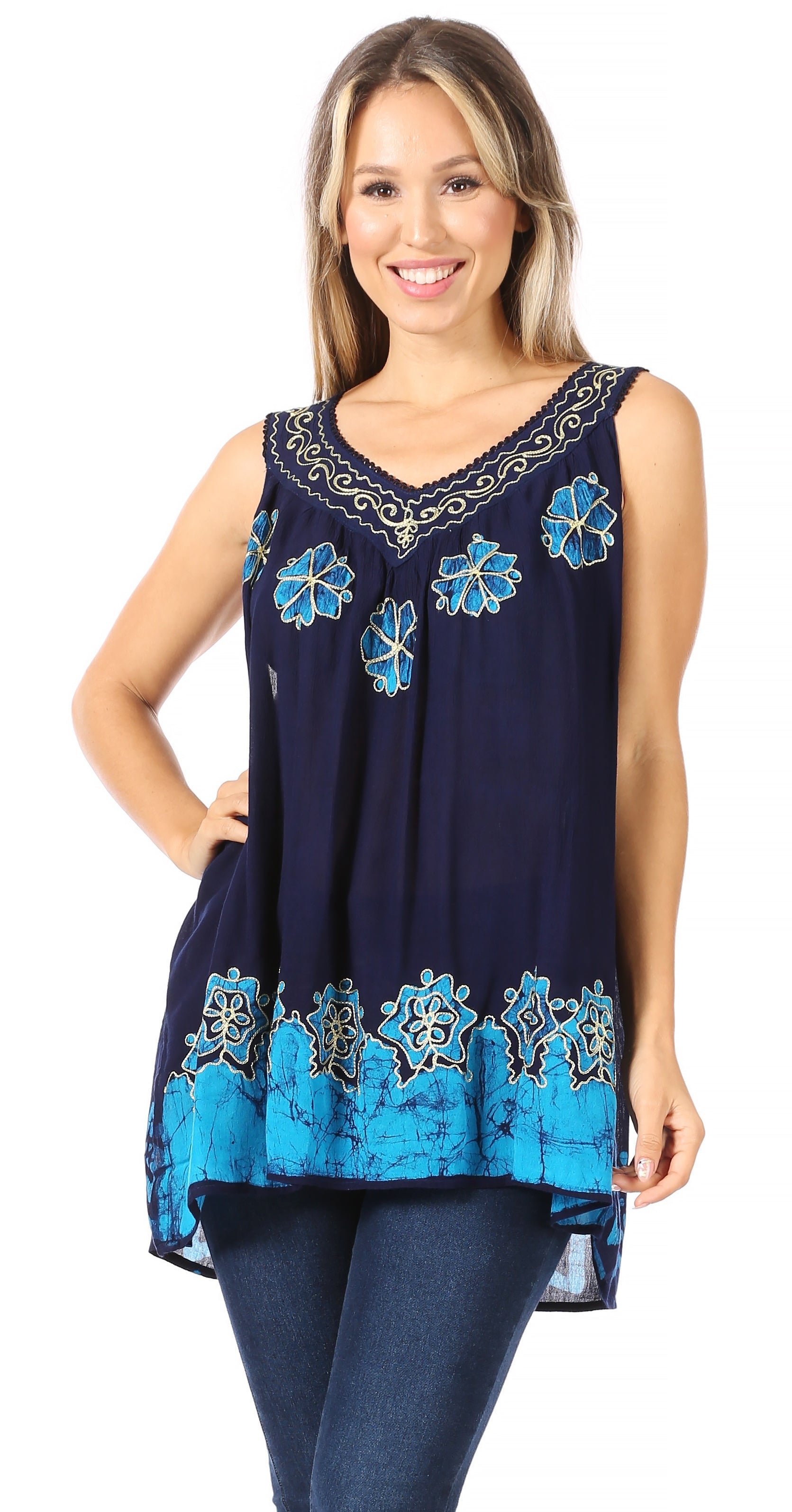 Woman wearing a navy sleeveless top with blue floral embroidery on a white background