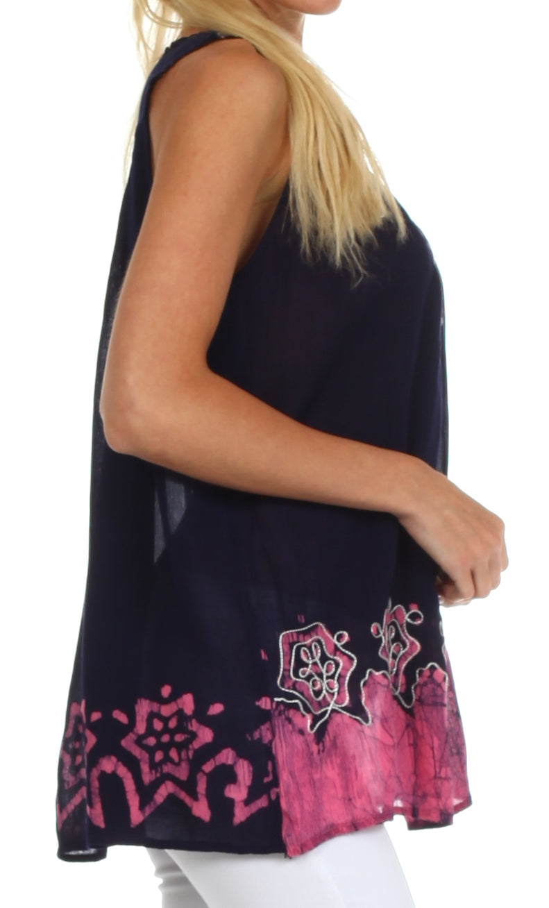 Black sleeveless top with pink patterns worn by a person on a white background