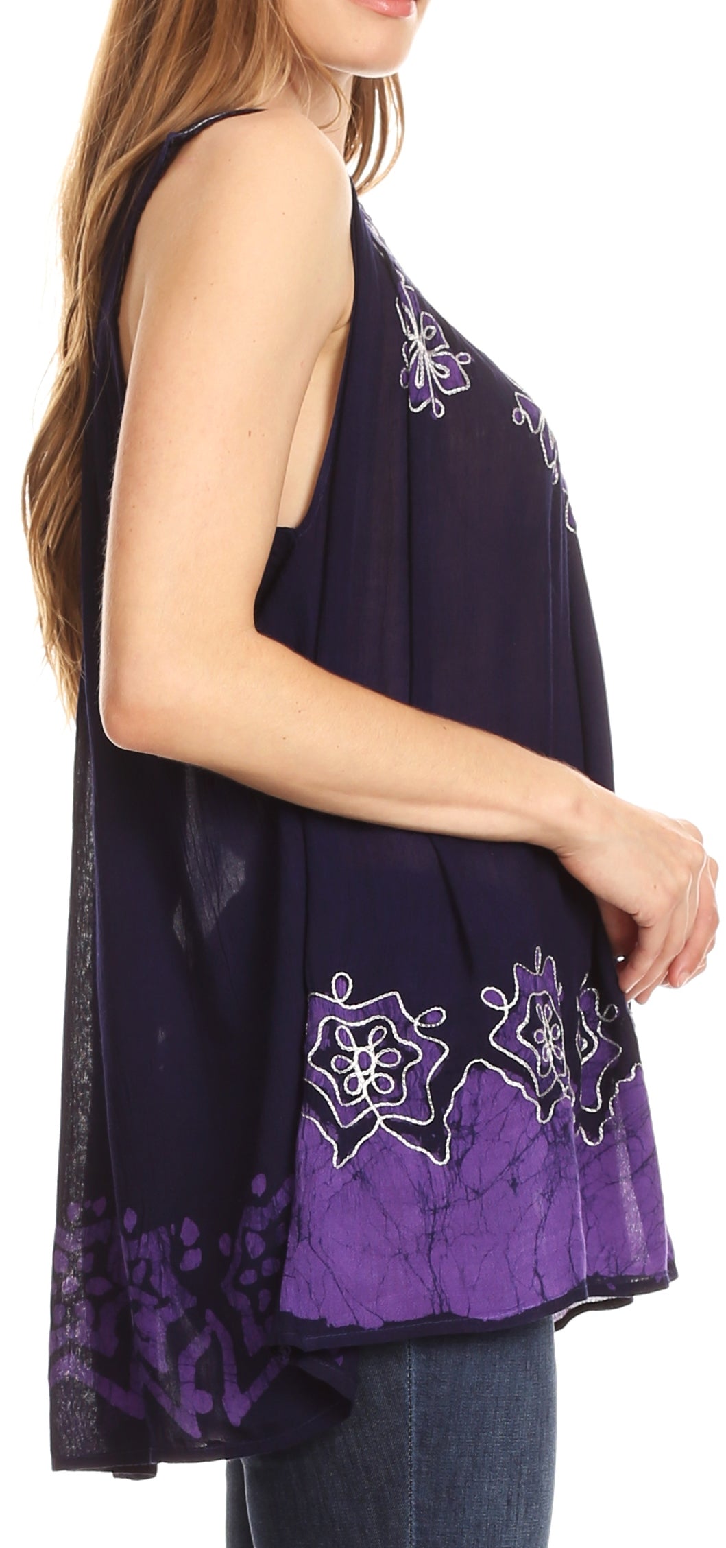 Woman wearing a sleeveless purple top with floral patterns on a white background