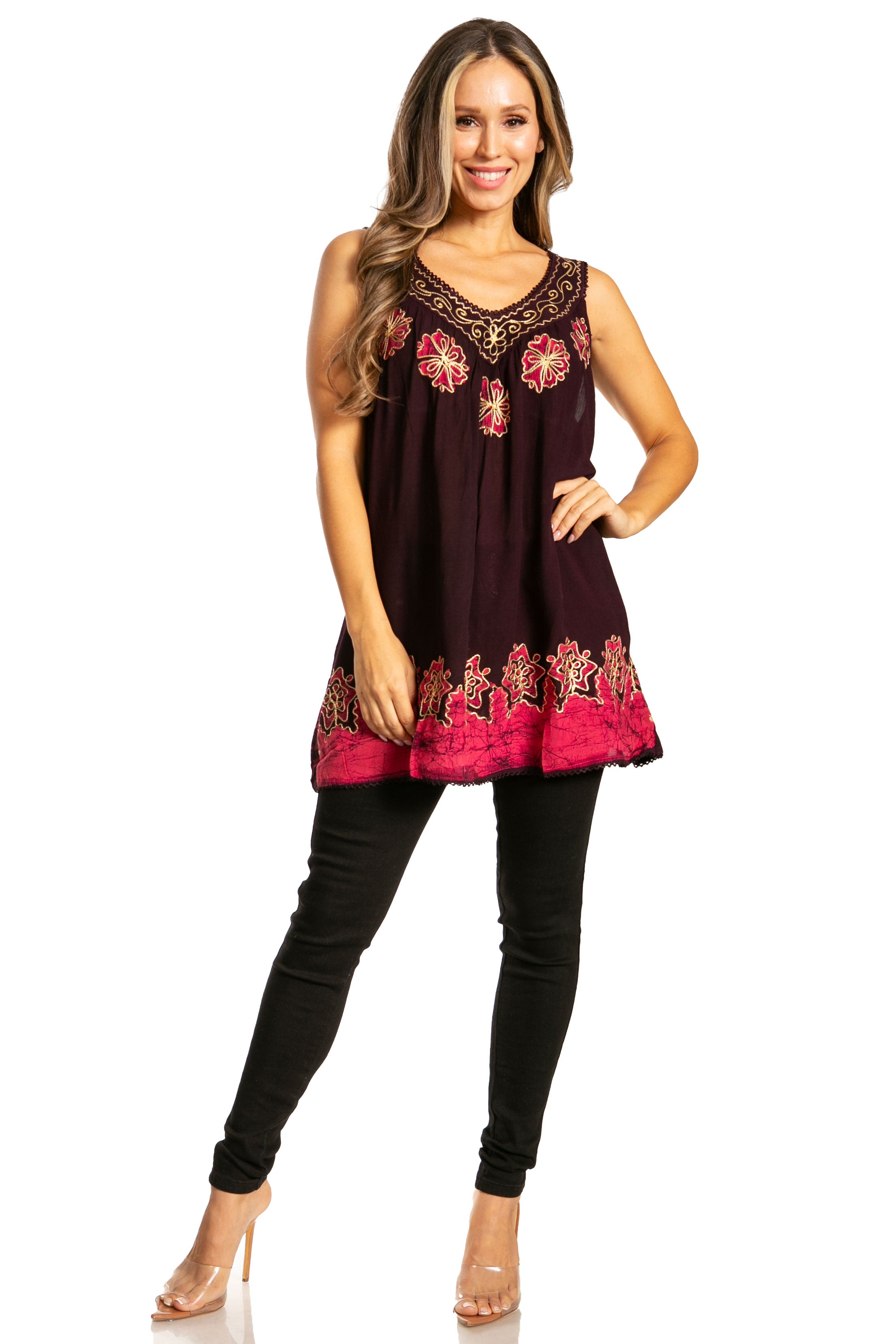 Woman wearing a burgundy sleeveless top with red floral embroidery and black pants on a white background