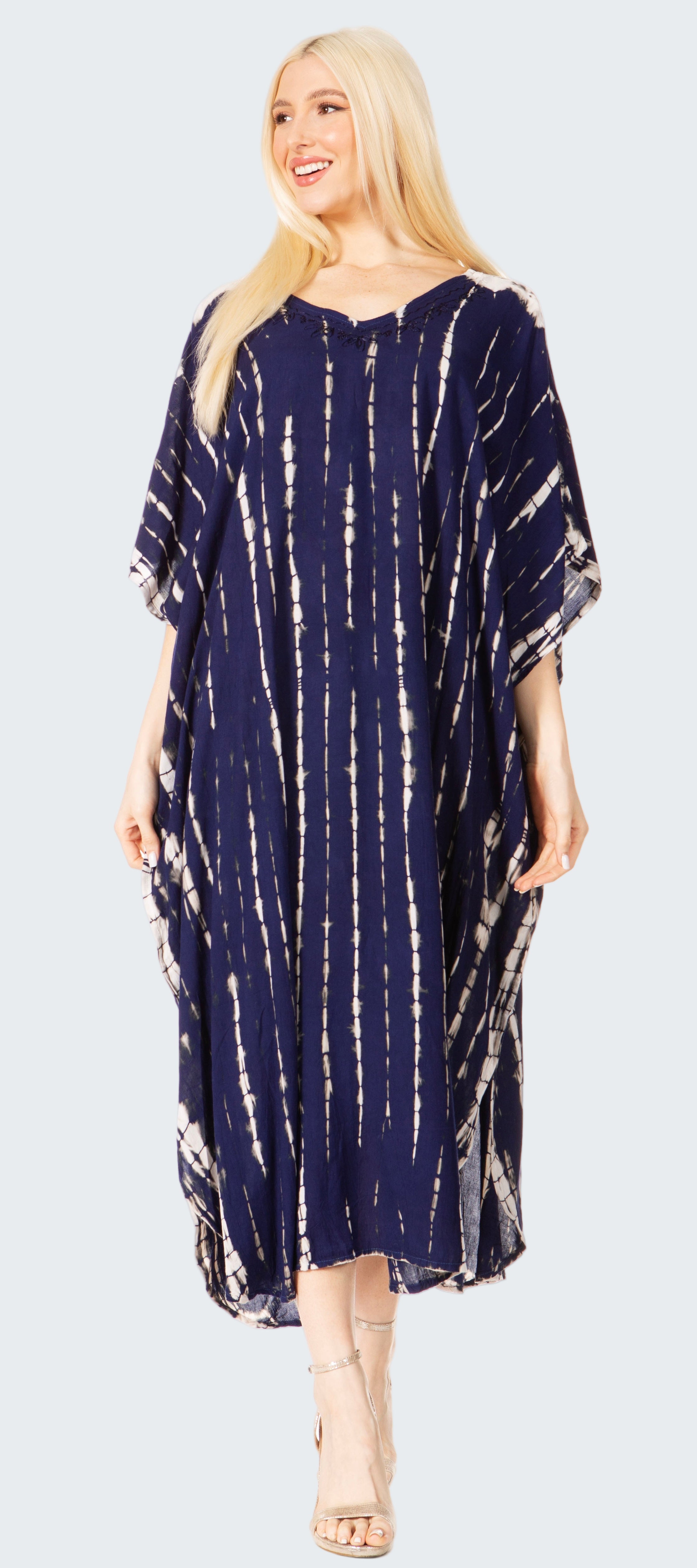 Woman wearing a navy blue tie-dye dress on a white background