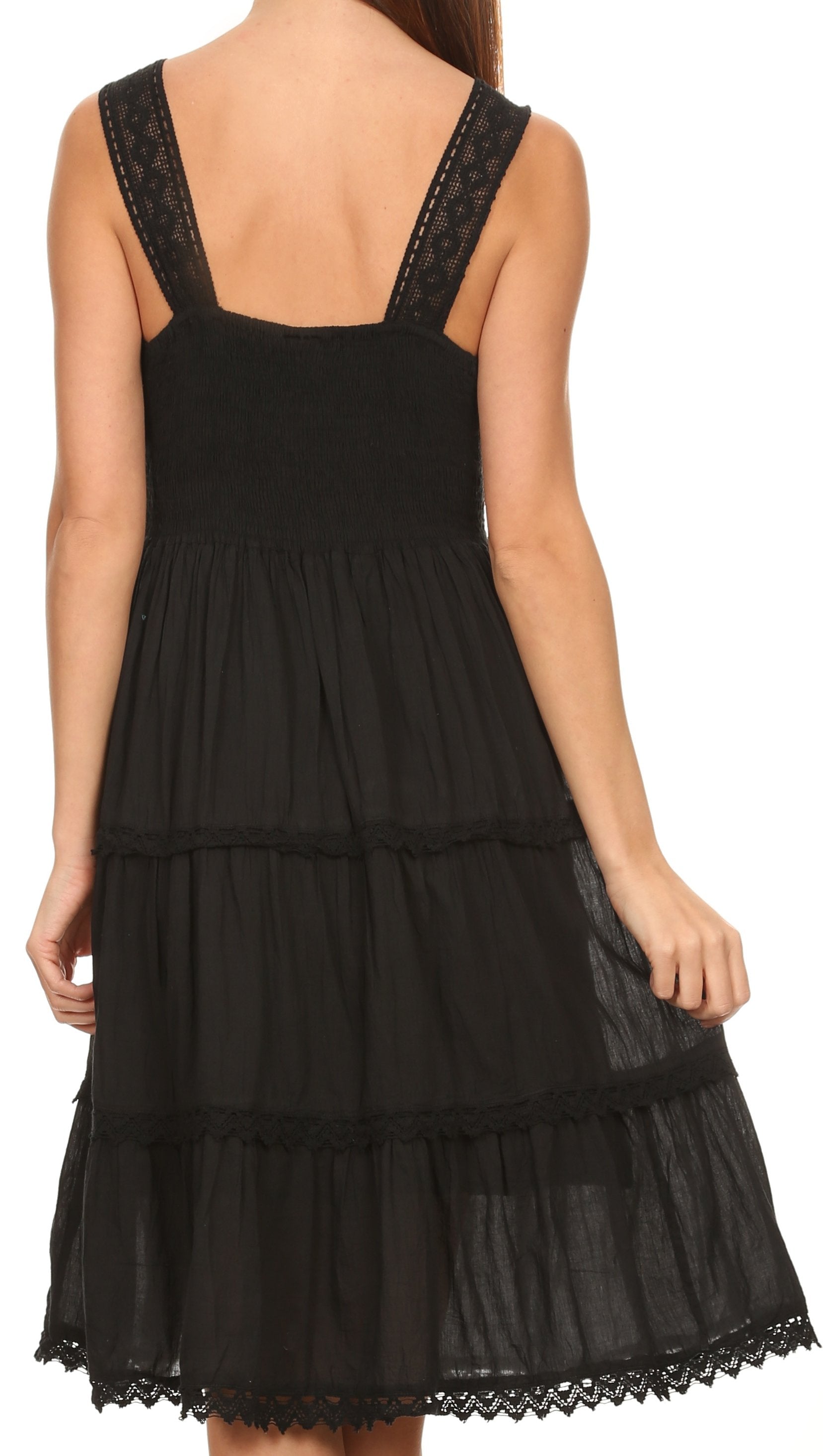 Black tiered dress with lace details on a white background