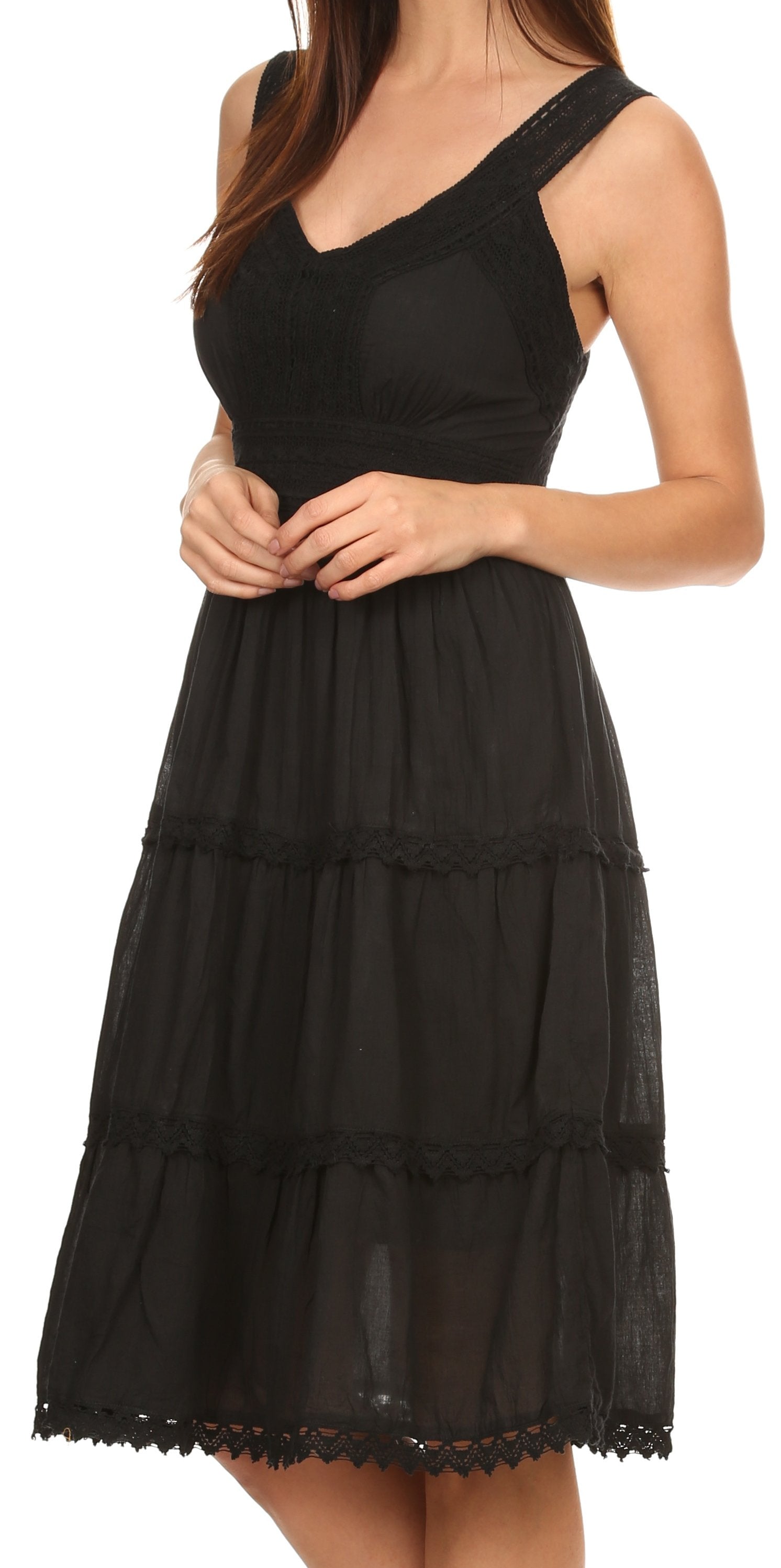 Black tiered dress with lace details on a white background