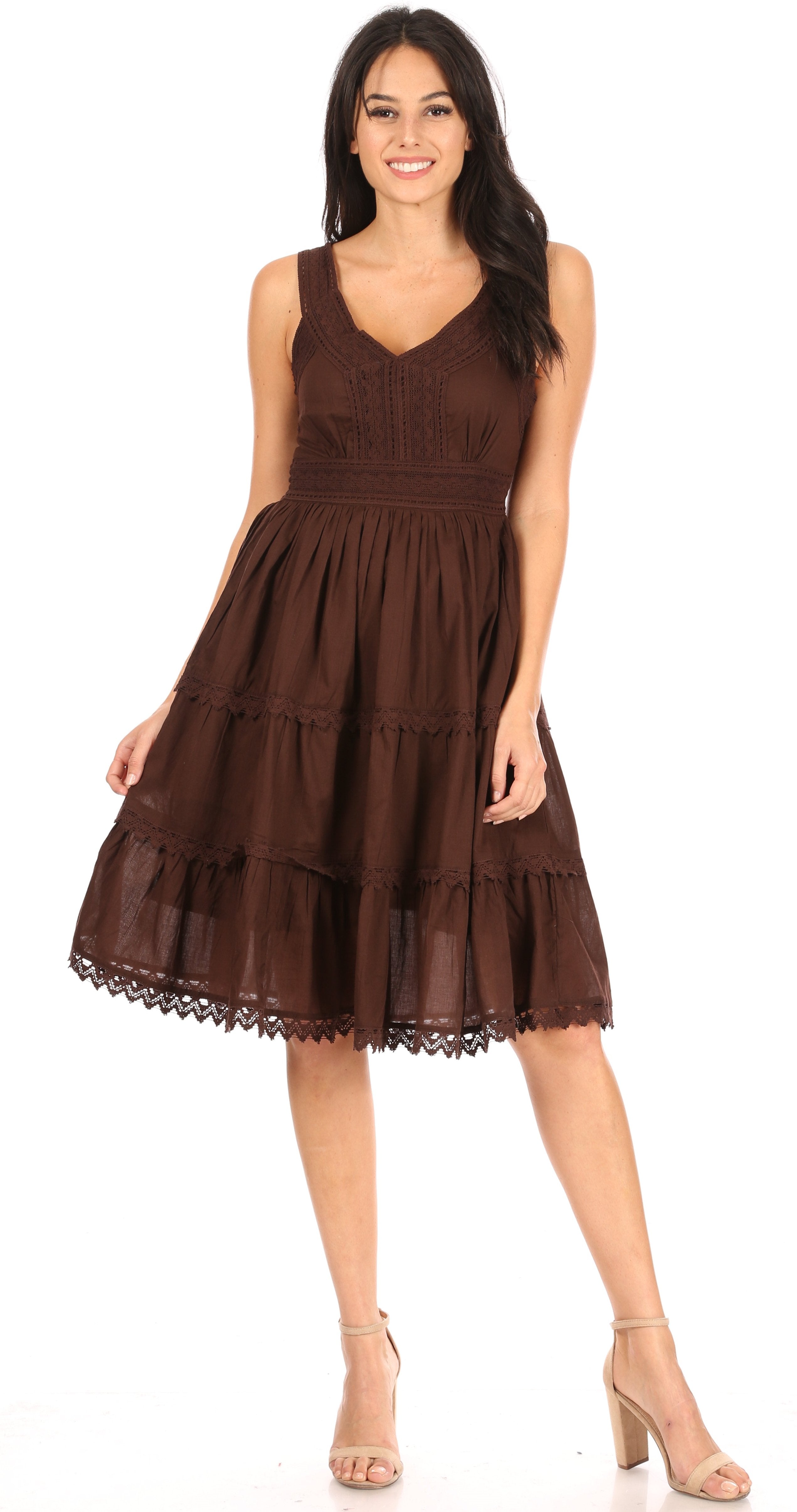 Woman wearing a brown dress with lace details on a white background