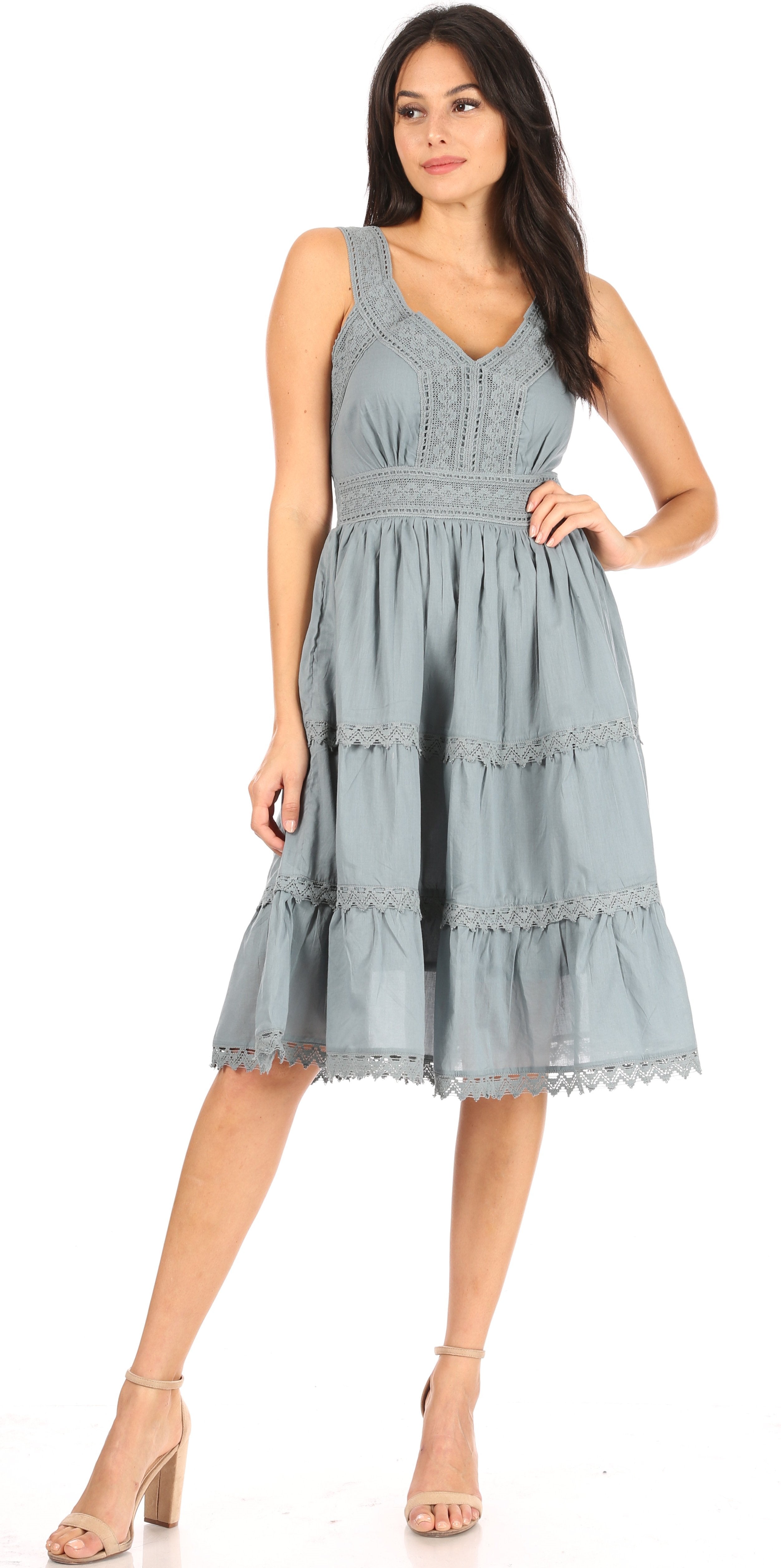 Woman wearing a light blue dress with ruffled details on a white background