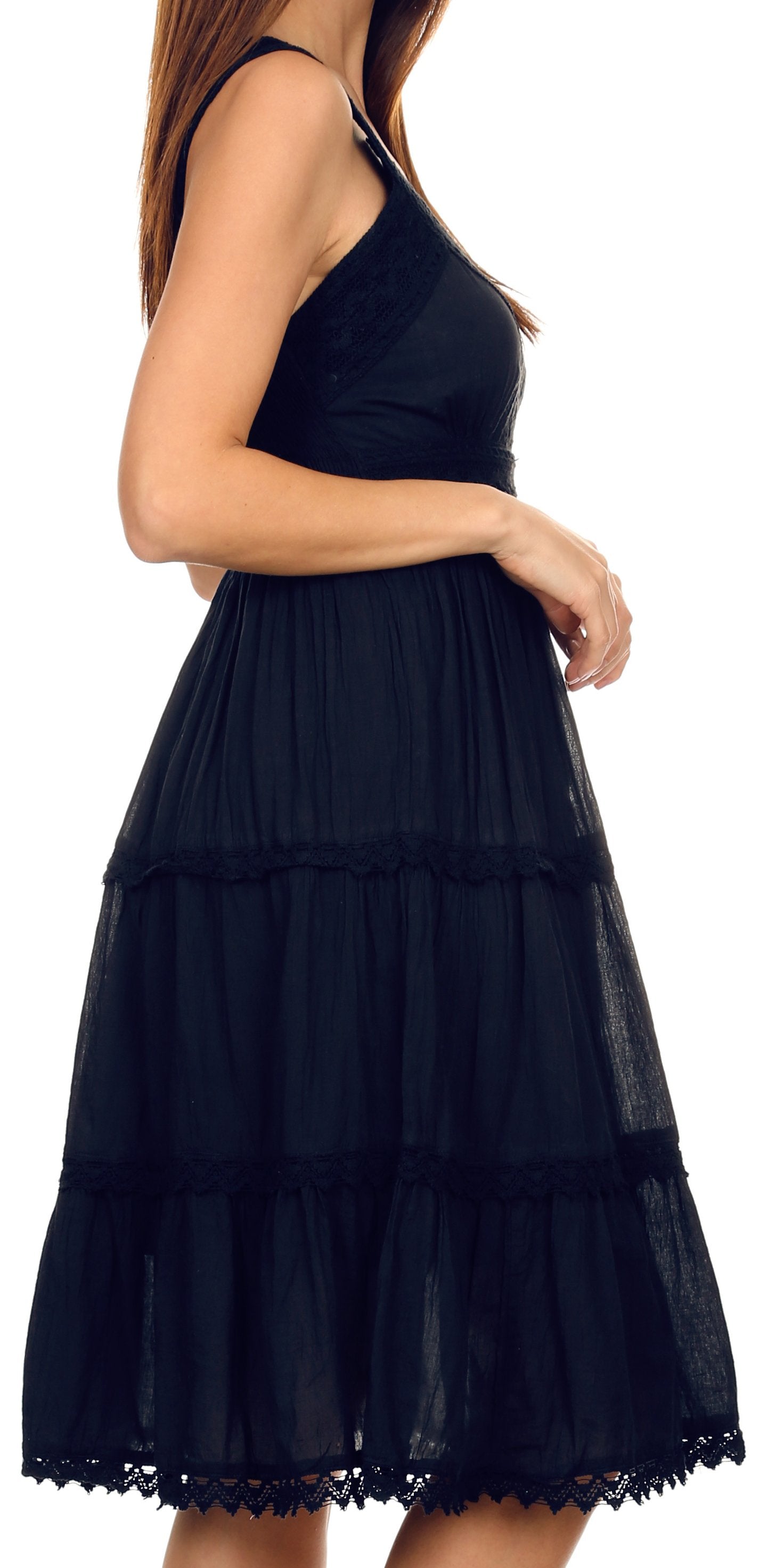 Black tiered dress worn by a person on a white background