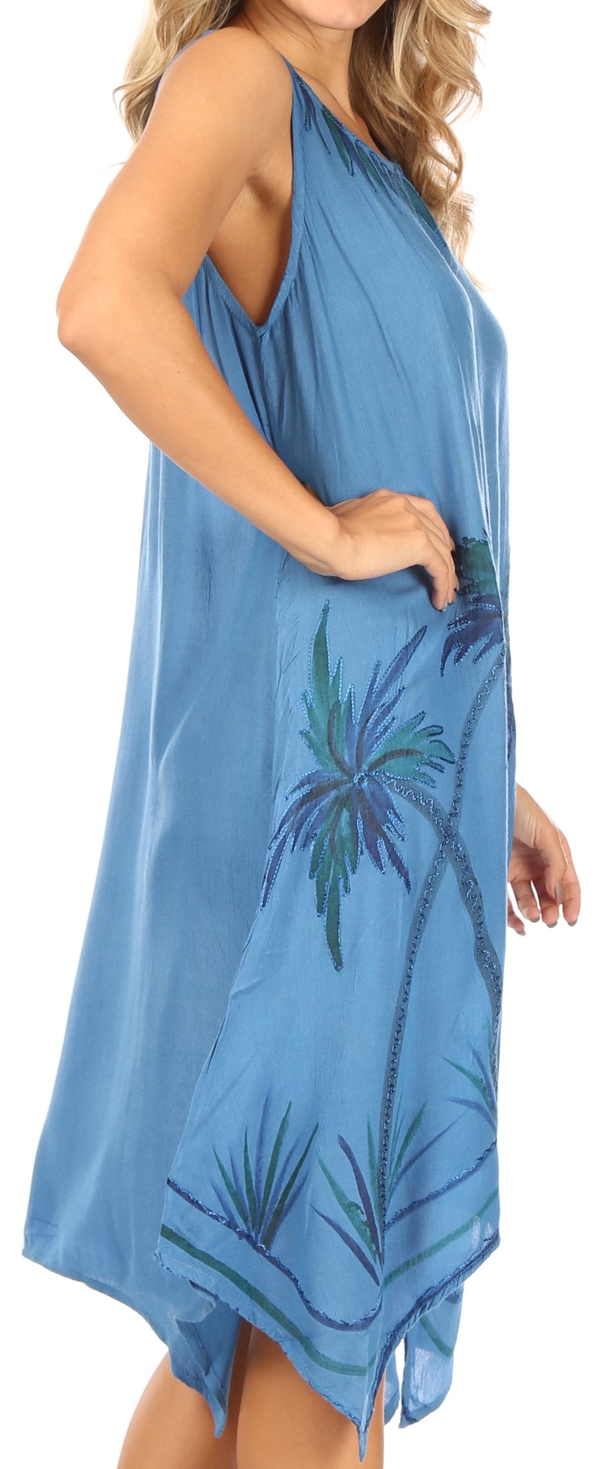 Woman wearing a blue dress with palm tree design