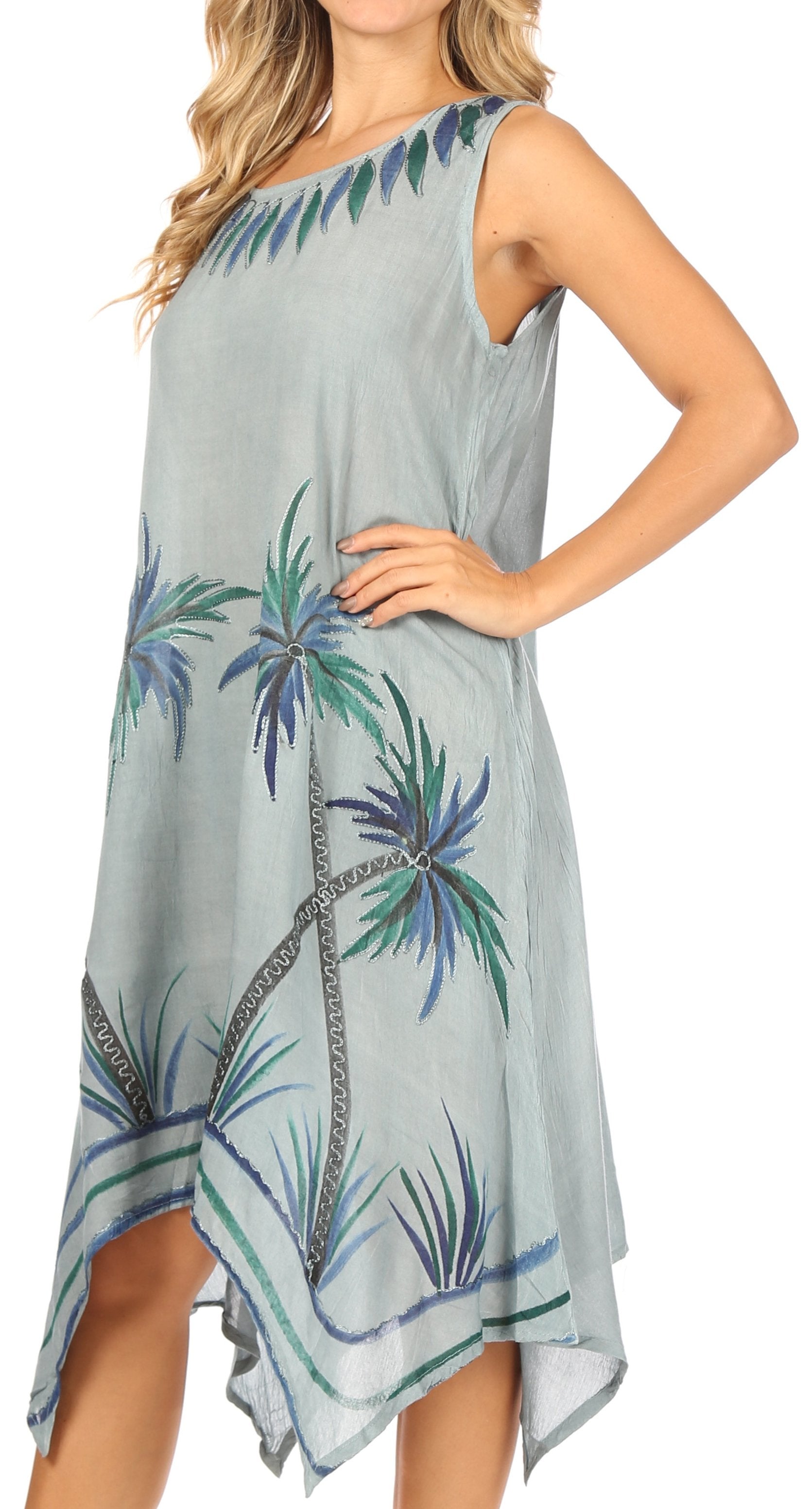 Woman wearing a sleeveless dress with palm tree pattern on a white background