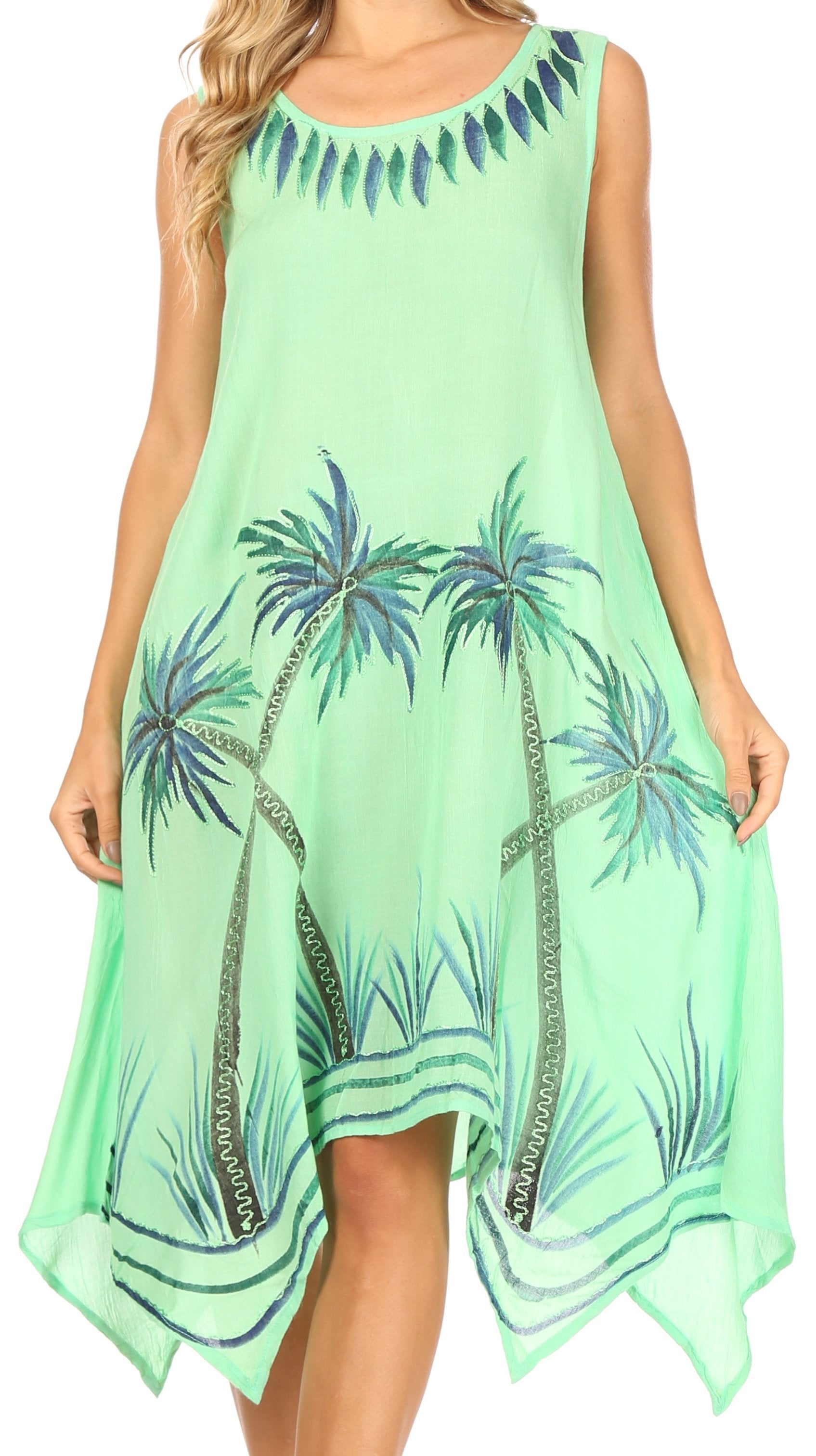Green dress with palm tree pattern worn by a model on a white background