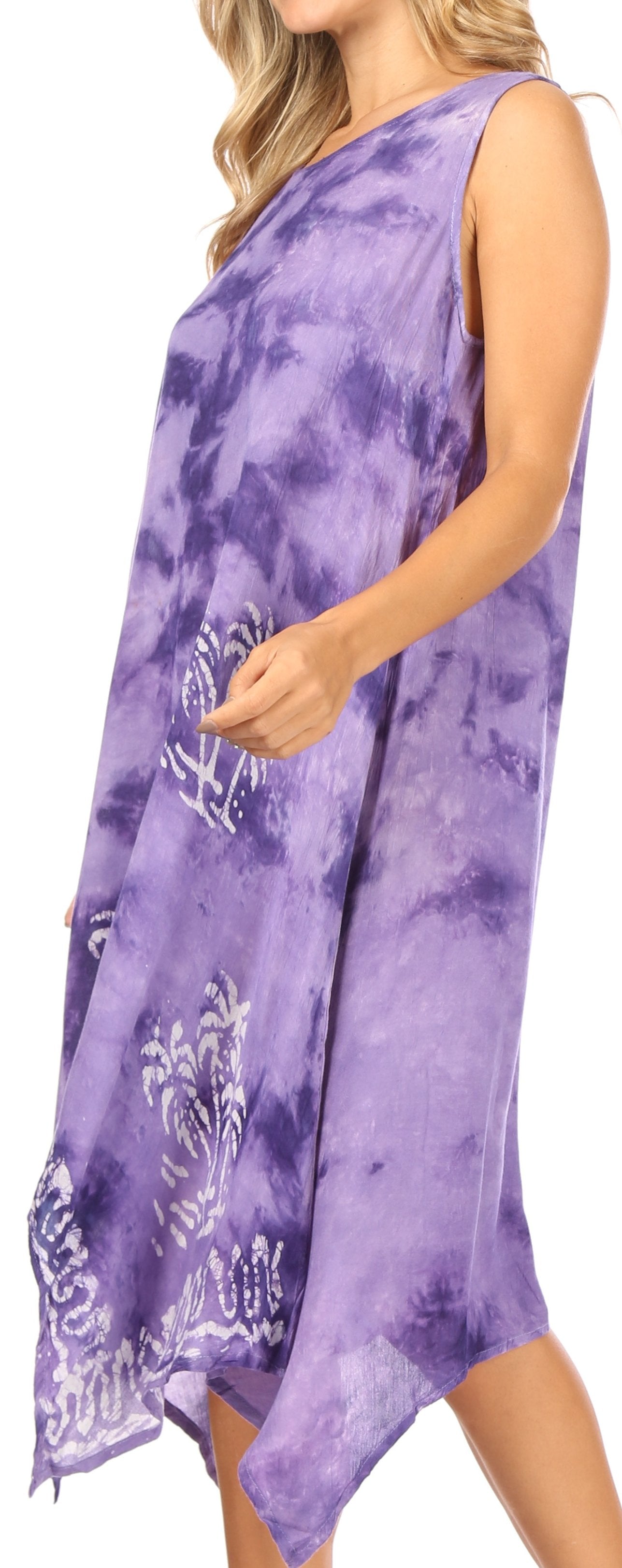 Woman wearing a purple tie-dye dress with a white pattern on a plain background