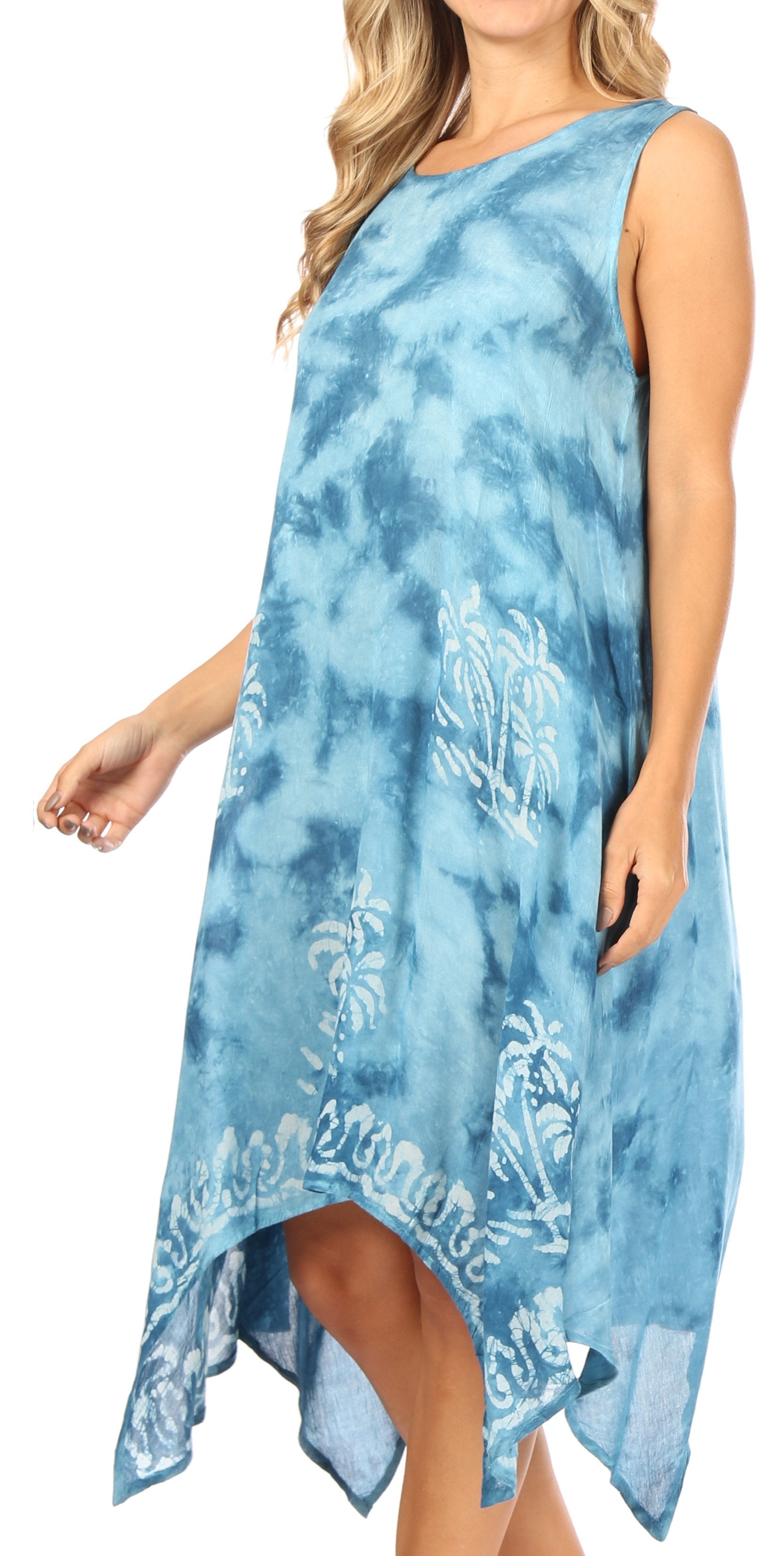 Woman wearing a blue tie-dye dress with floral patterns on a white background