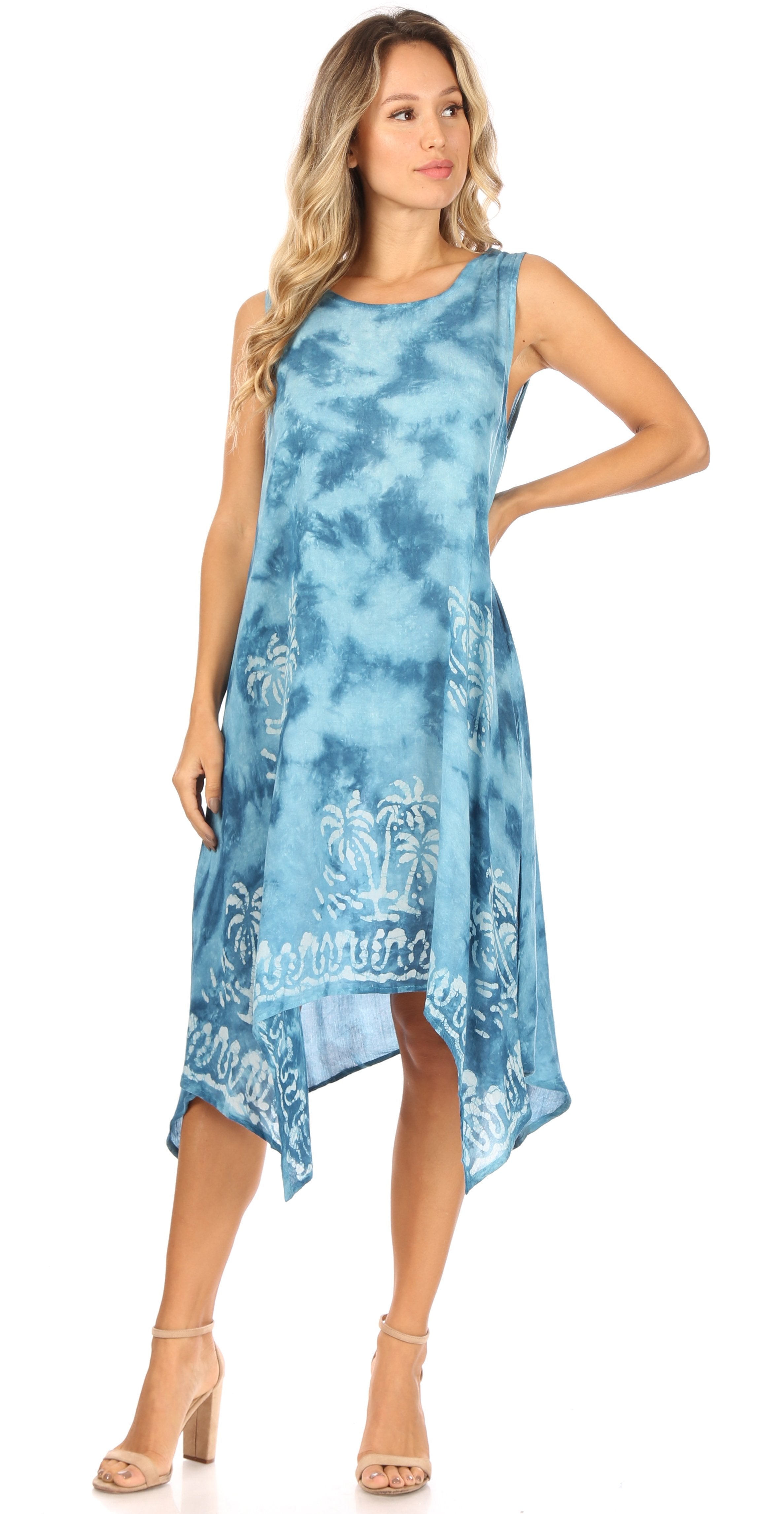 Woman wearing a blue tie-dye dress with floral patterns on a white background