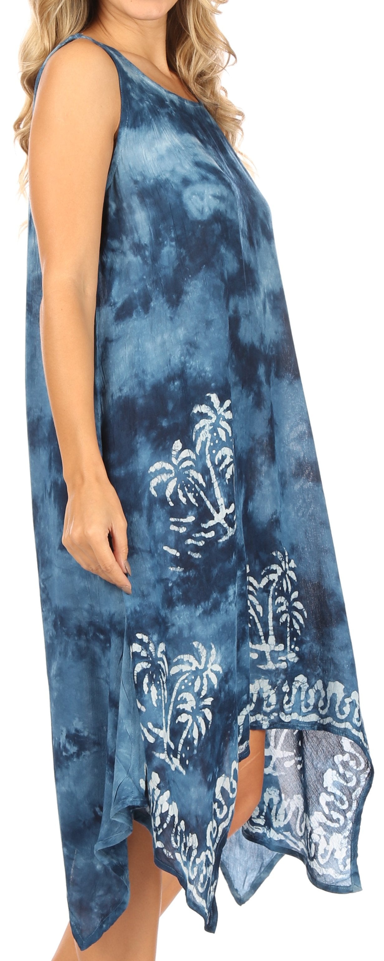 Woman wearing a blue tie-dye dress with palm tree patterns on a white background