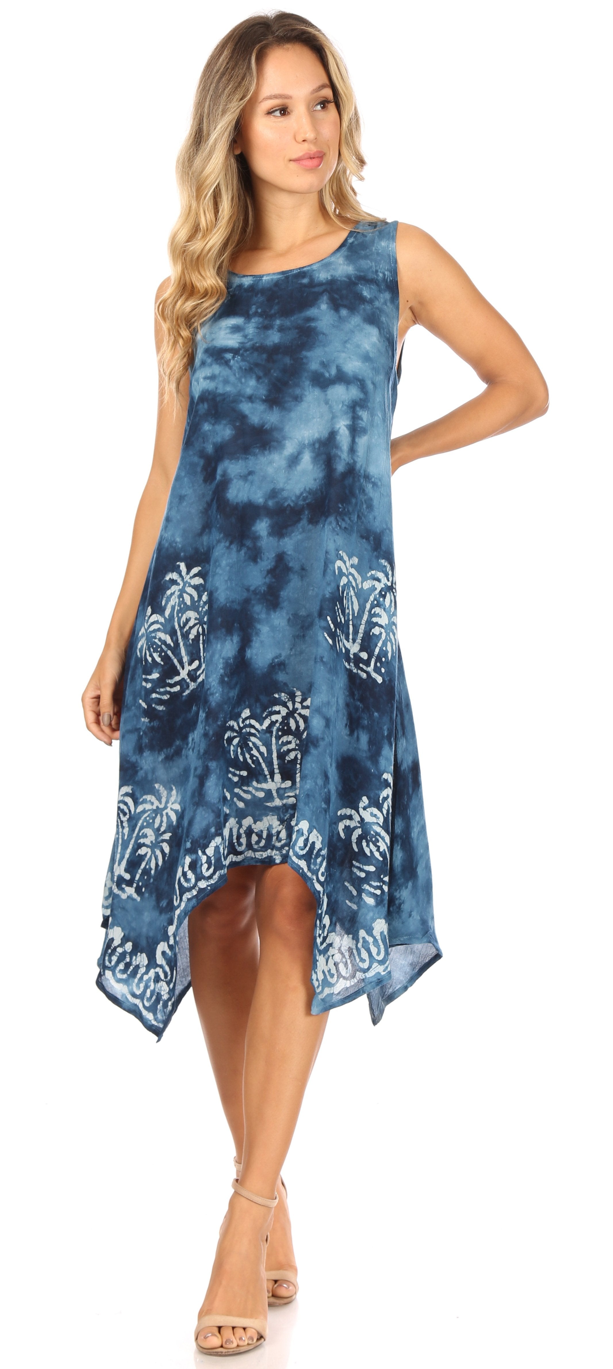 Woman wearing a blue tie-dye dress with floral patterns on a white background