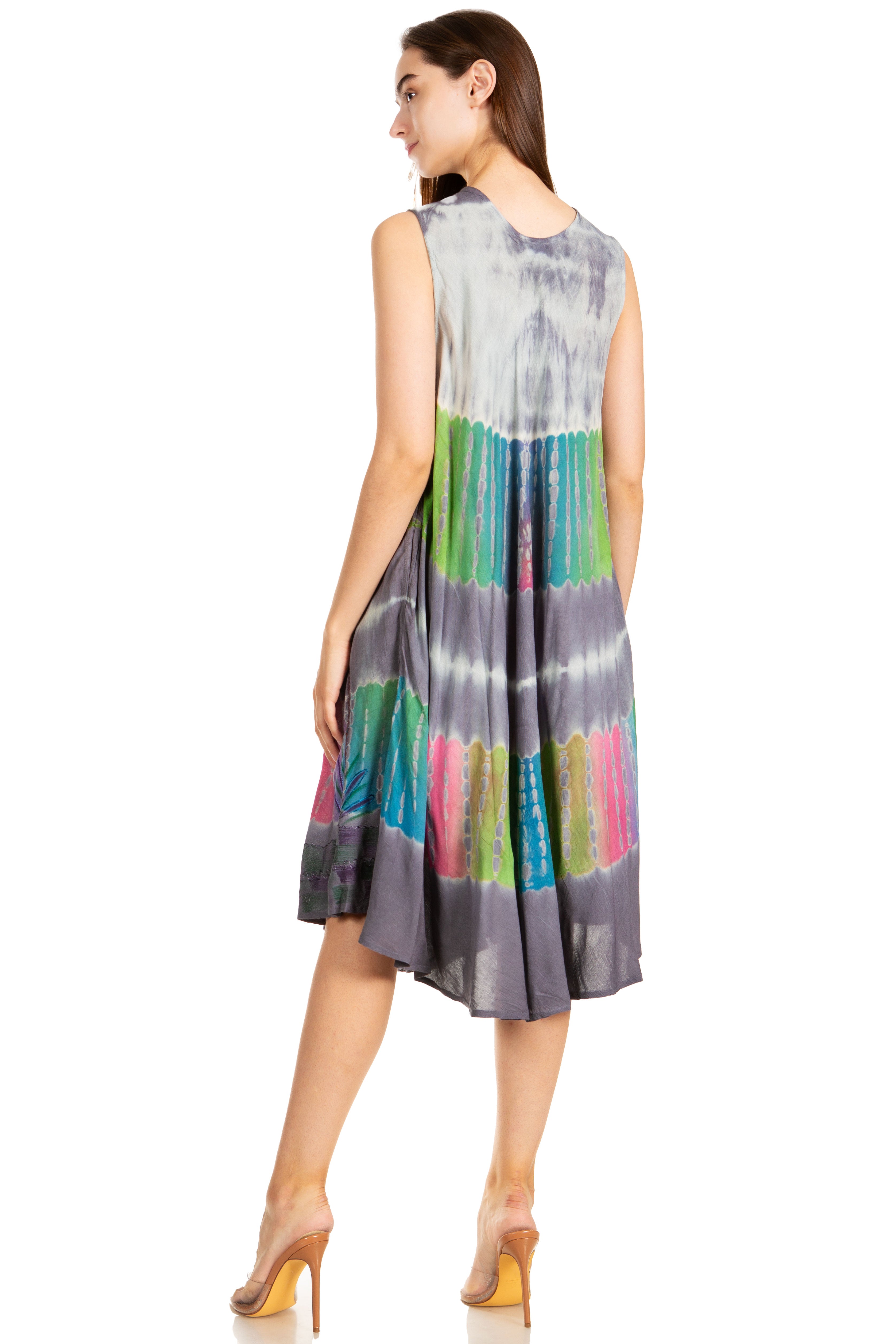 Woman wearing a sleeveless dress with a colorful tie-dye pattern on a white background