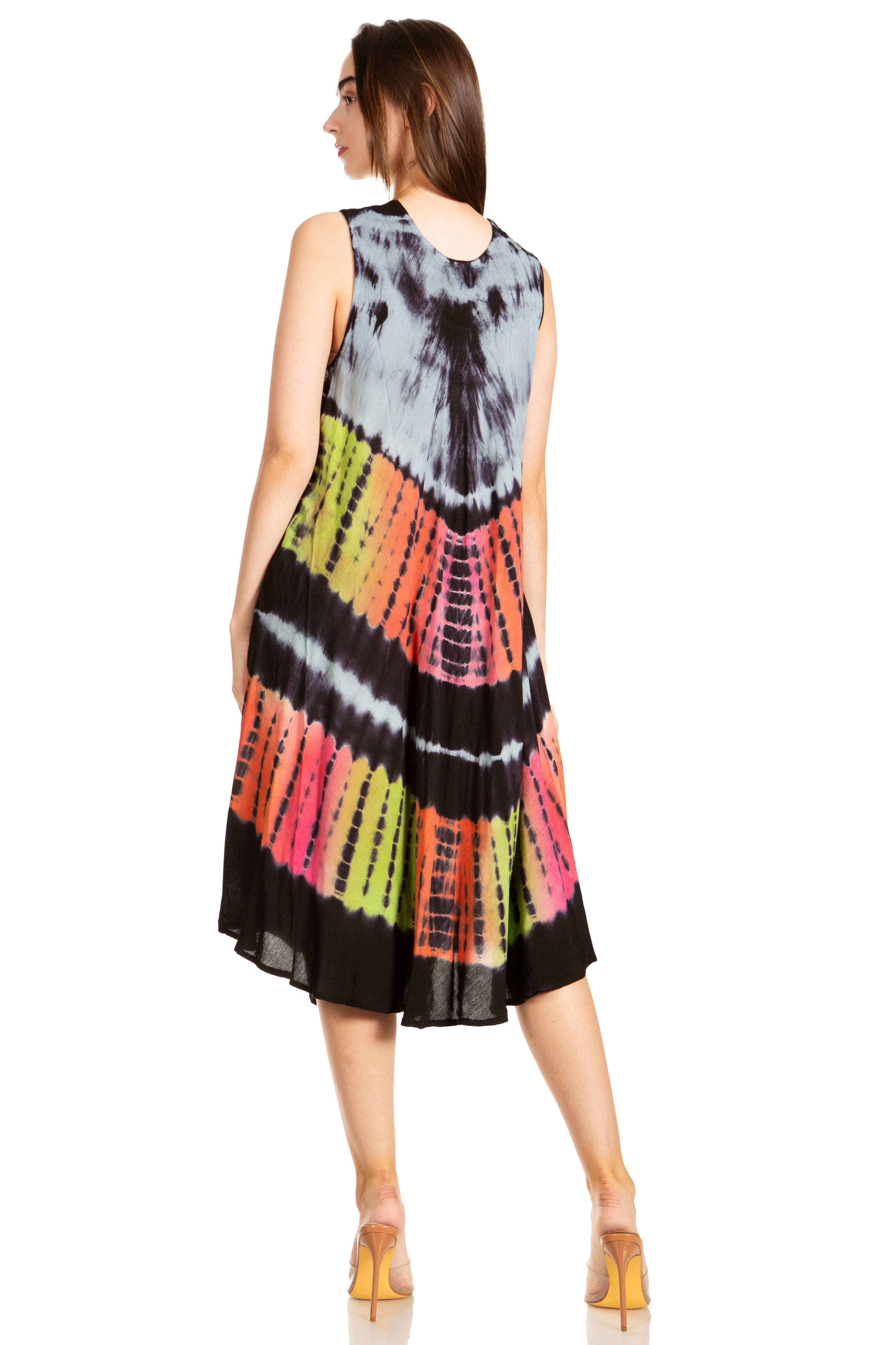 Woman wearing a tie-dye dress with a colorful pattern on a white background