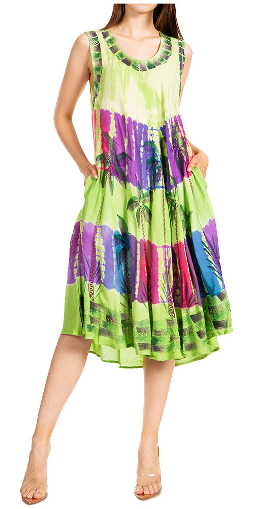 Woman wearing a colorful dress with a green base and multicolor pattern on a white background