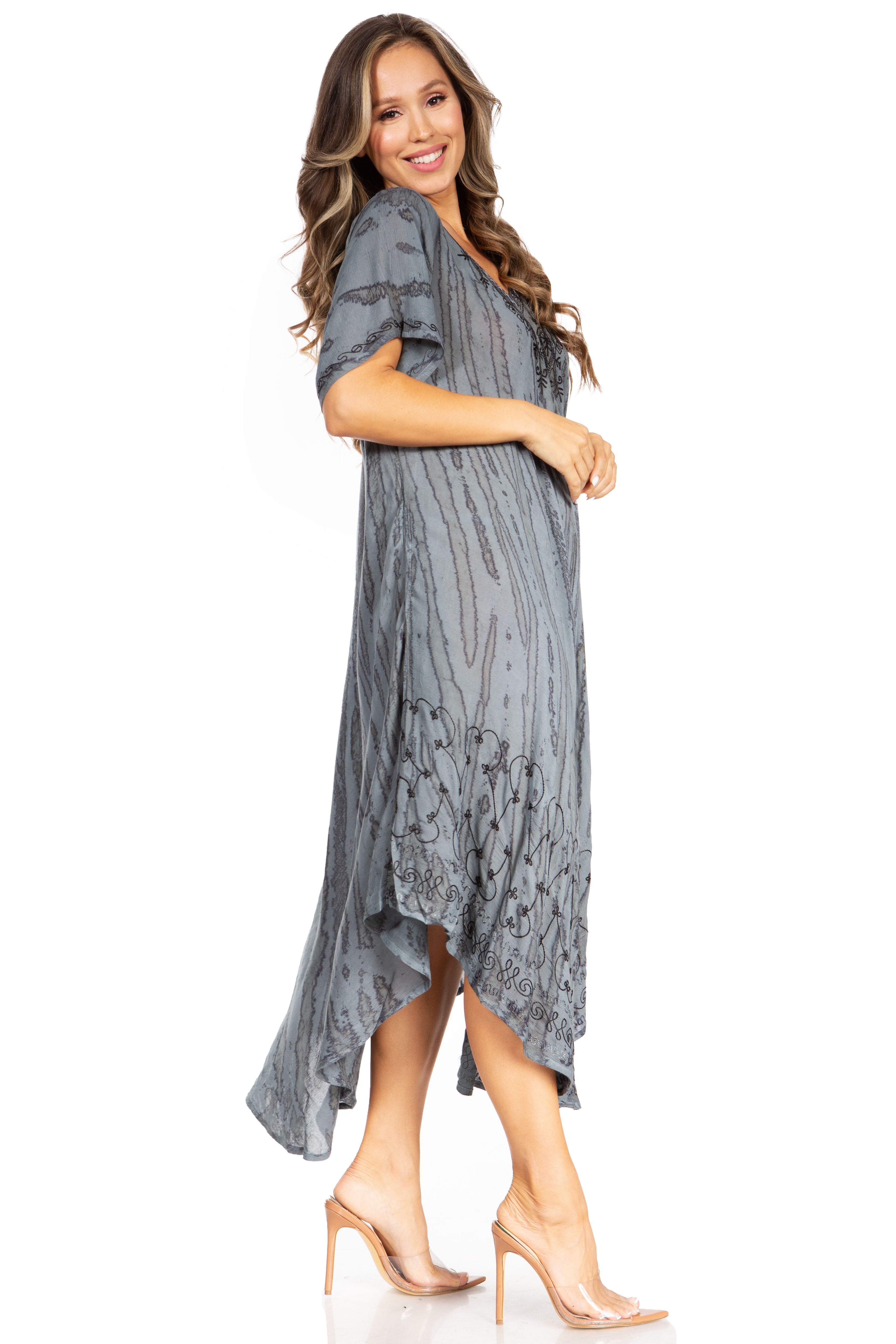Woman wearing a gray patterned dress on a white background