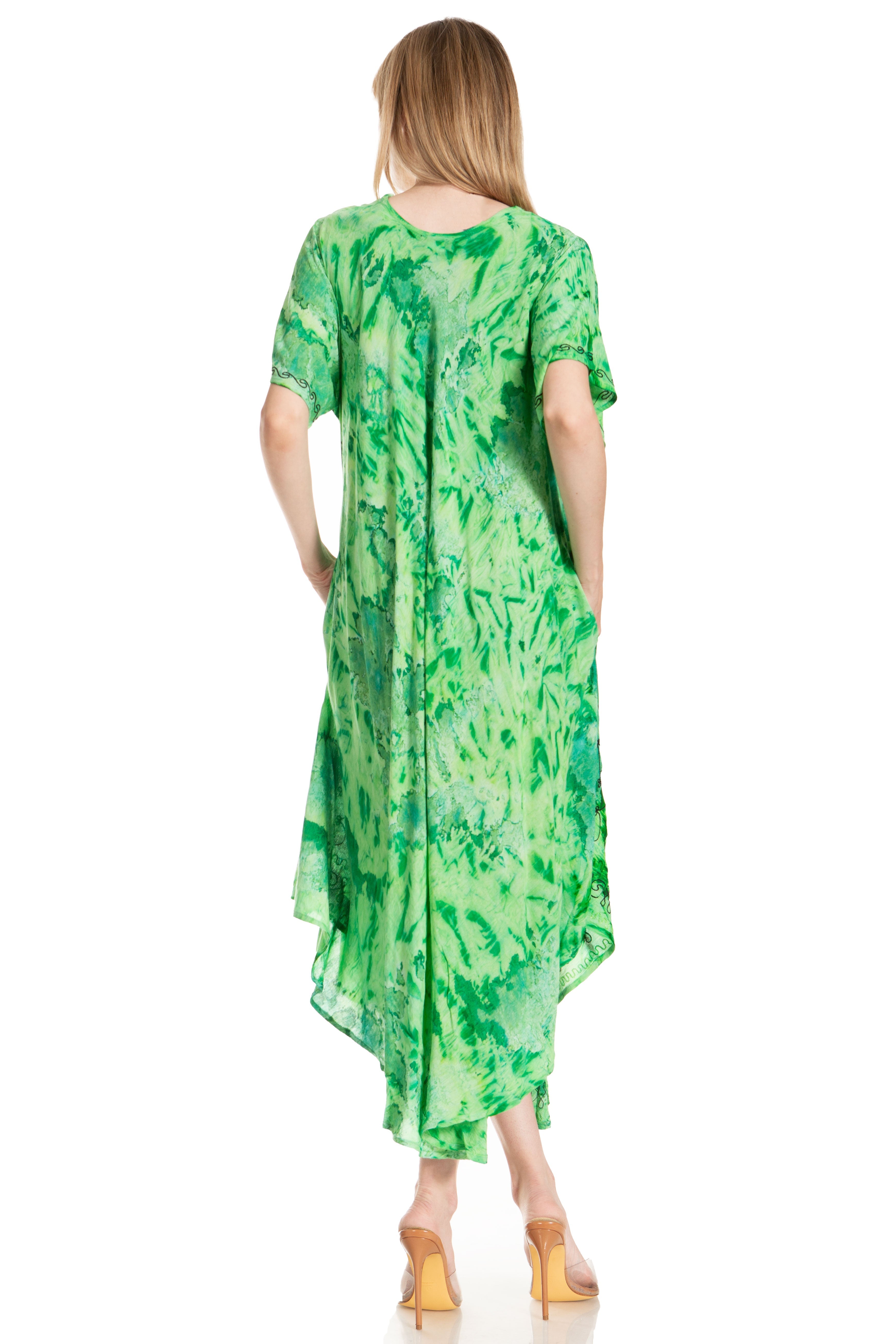 Woman wearing a green patterned dress on a white background