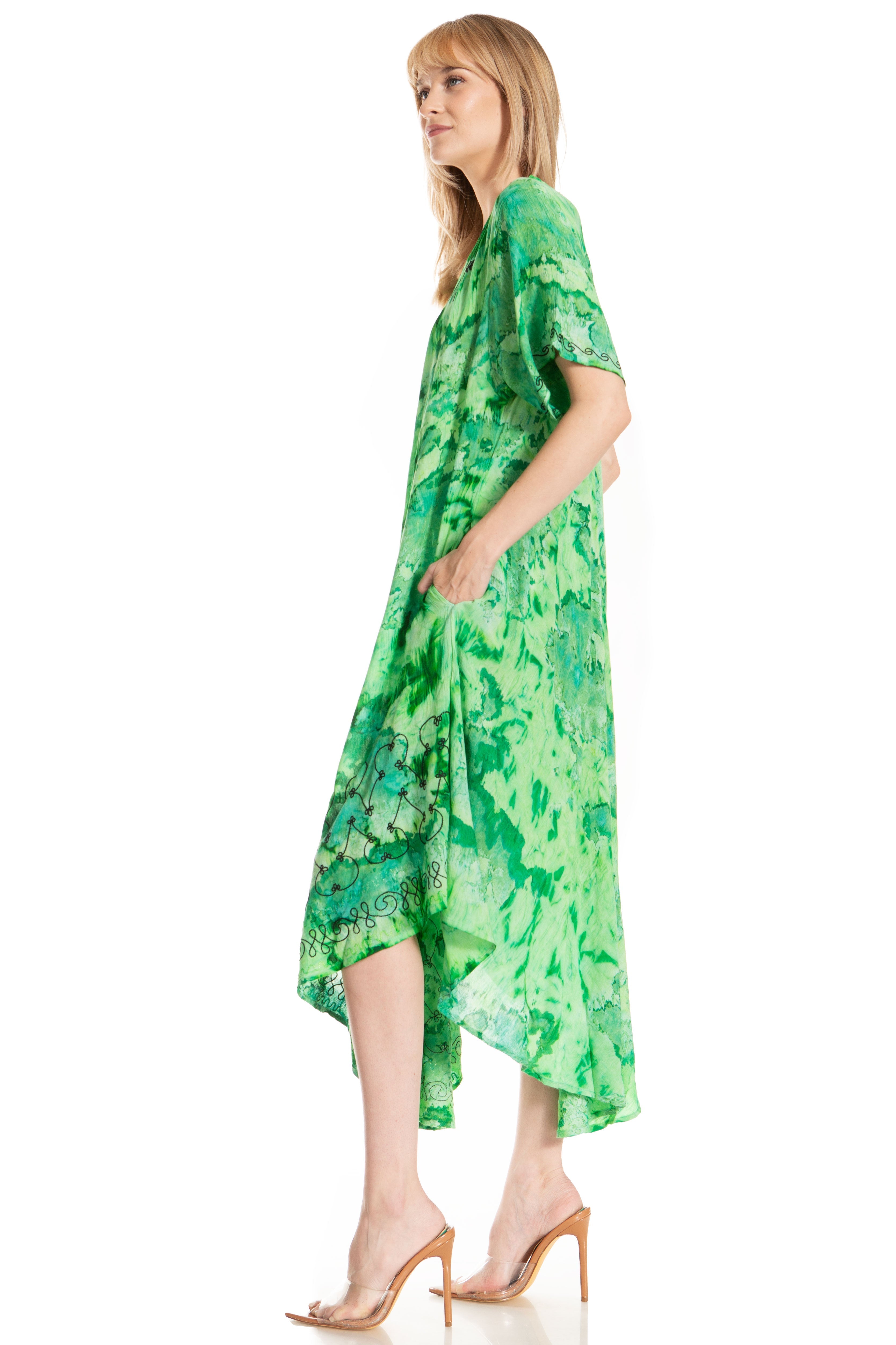 Woman wearing a green patterned dress on a white background