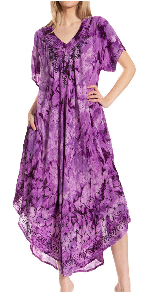 Woman wearing a purple patterned dress with a plain background