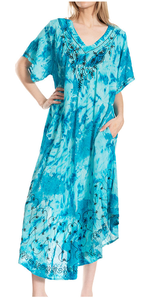 Woman wearing a blue tie-dye dress with floral patterns on a white background