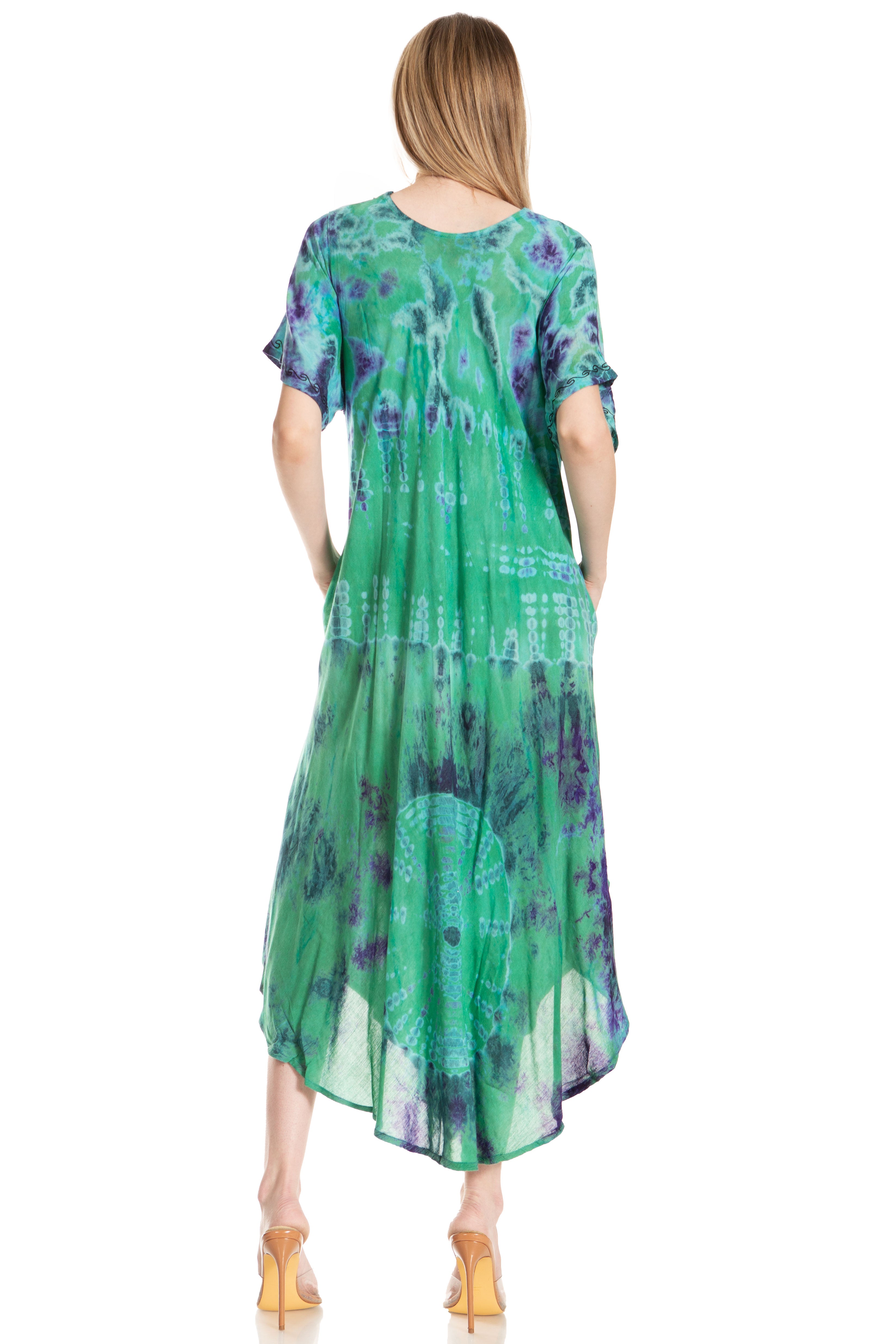 Woman wearing a green and purple patterned dress on a white background