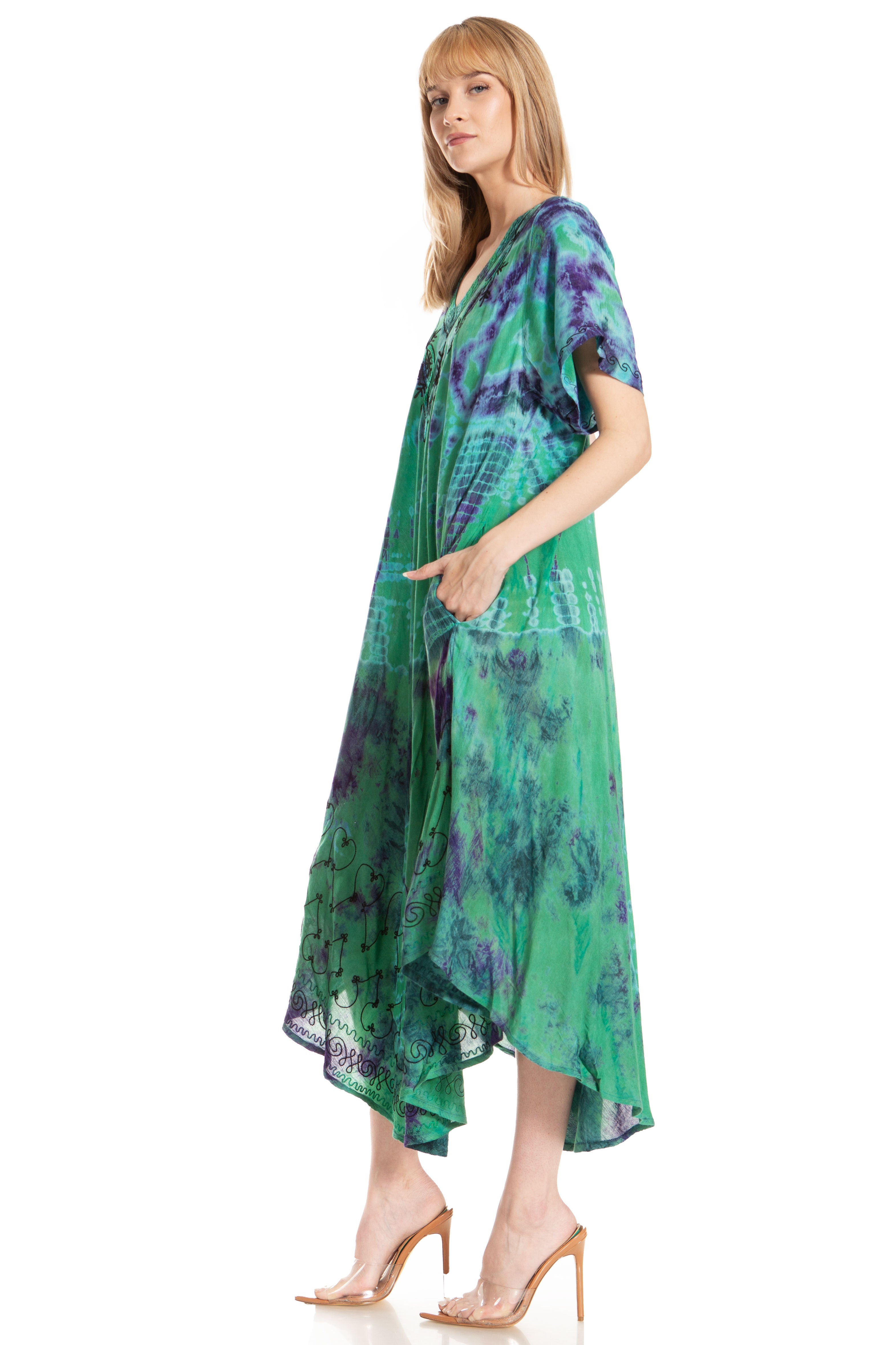 Woman wearing a green and purple patterned dress on a white background