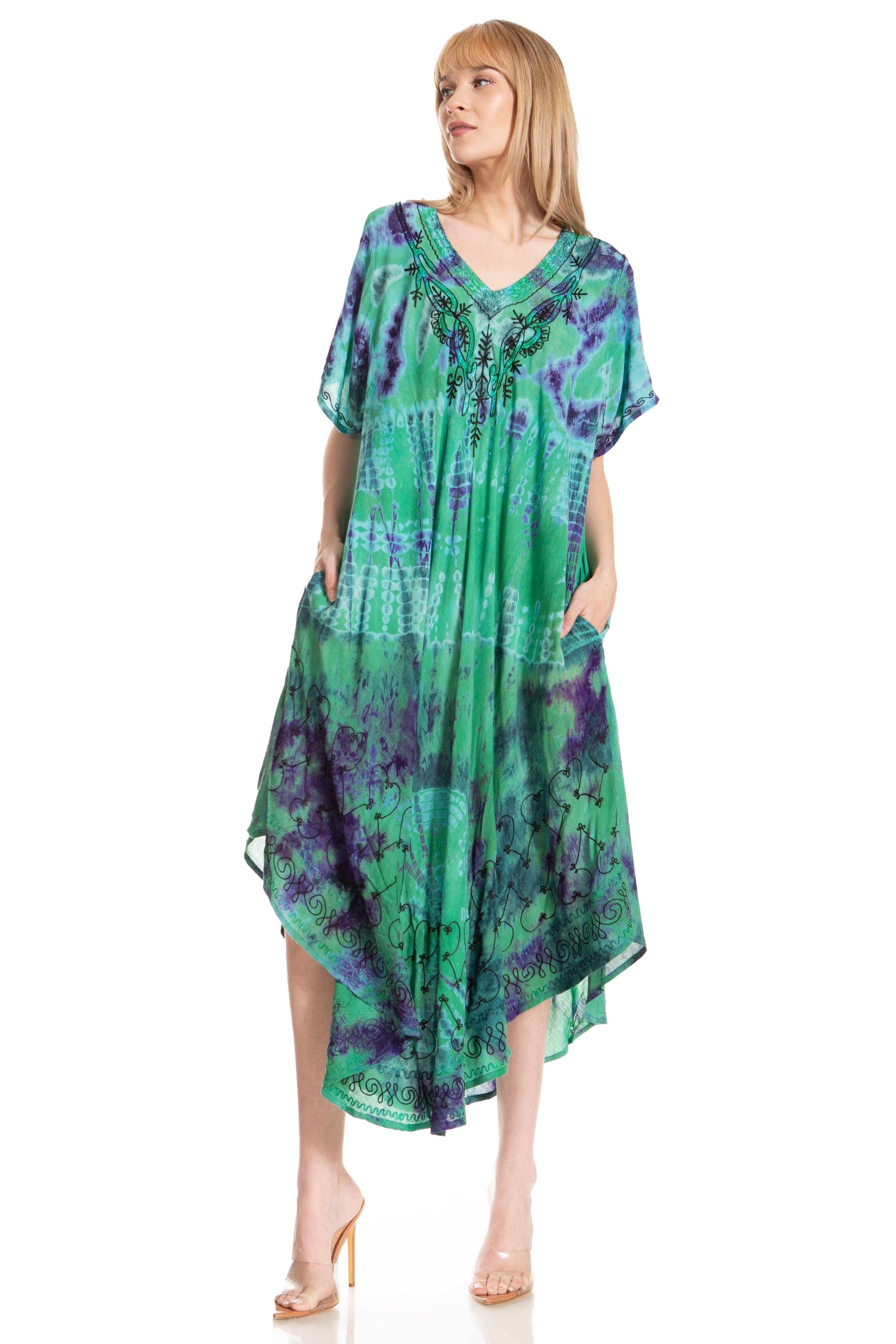 Woman wearing a green and purple patterned dress on a white background