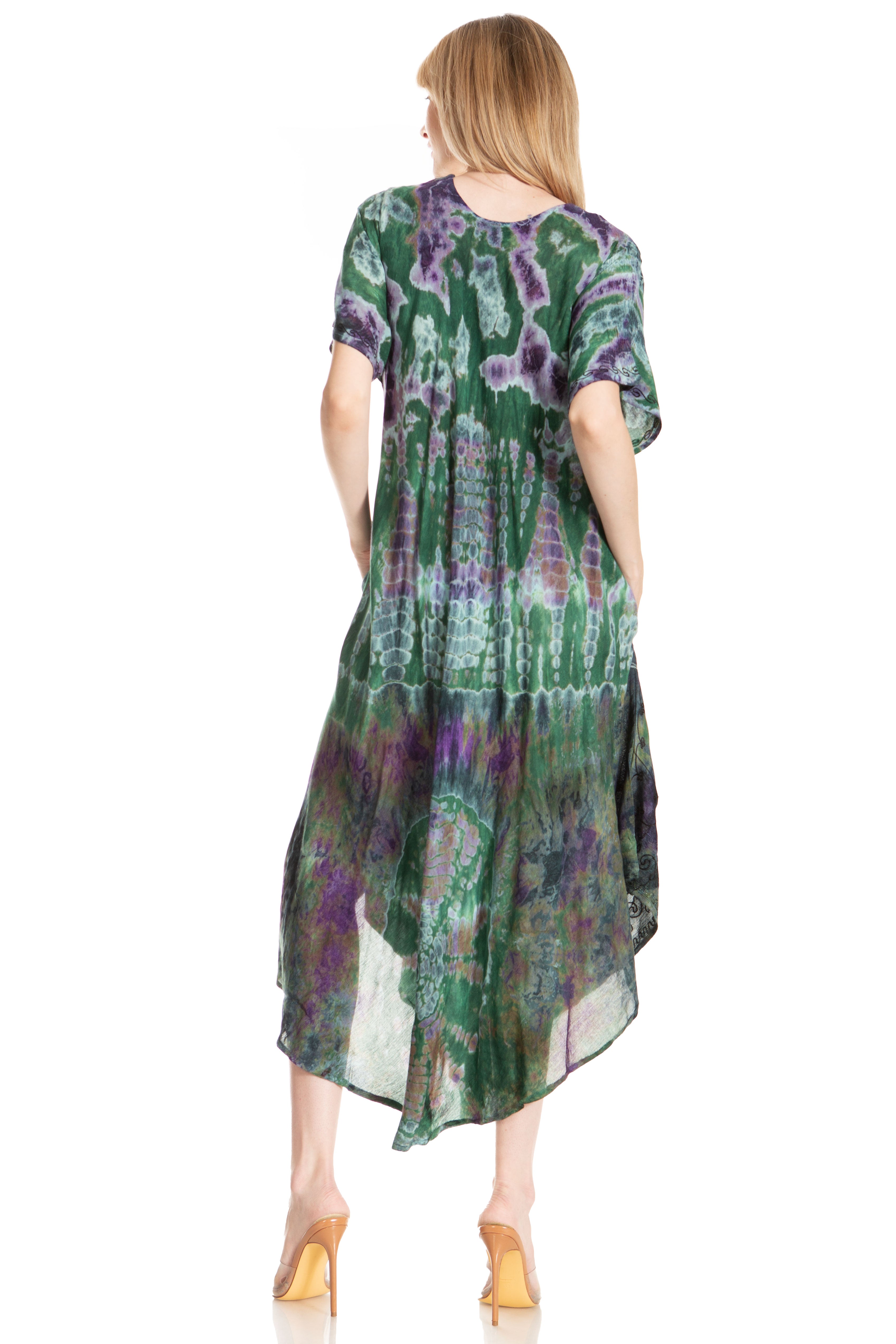 Woman wearing a green and purple patterned dress on a white background