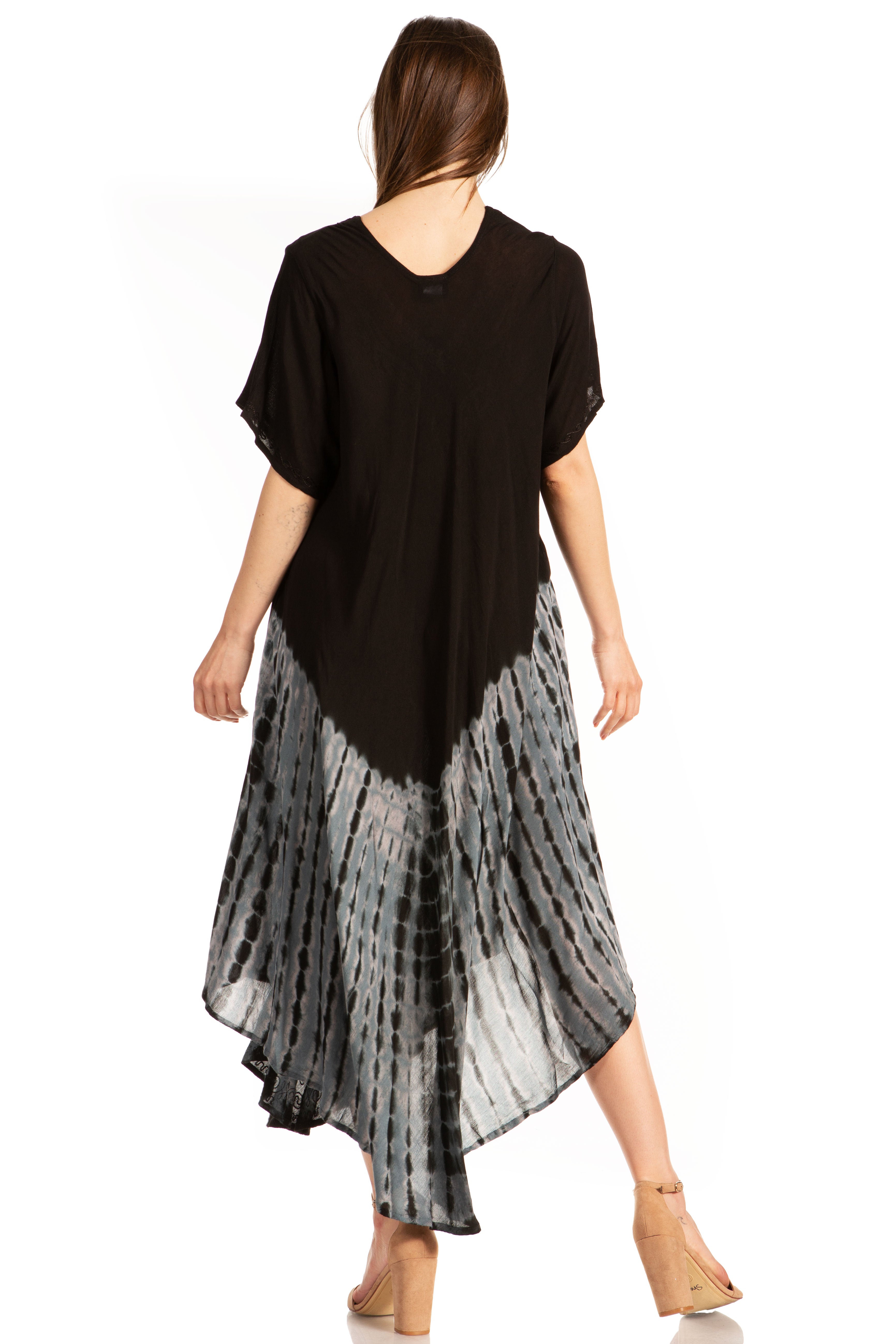 Woman wearing a black top and patterned skirt on a white background