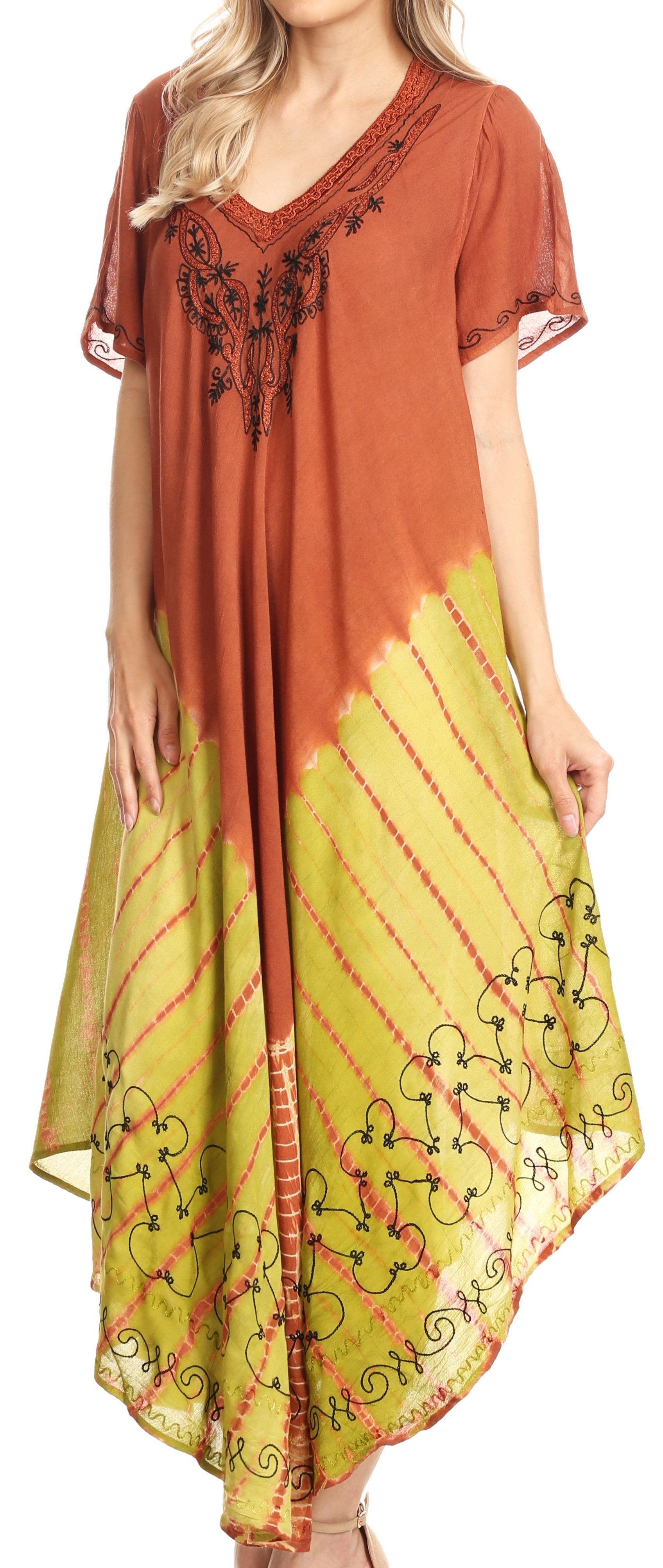 Woman wearing a rust-colored top and yellow tie-dye skirt with floral embroidery.