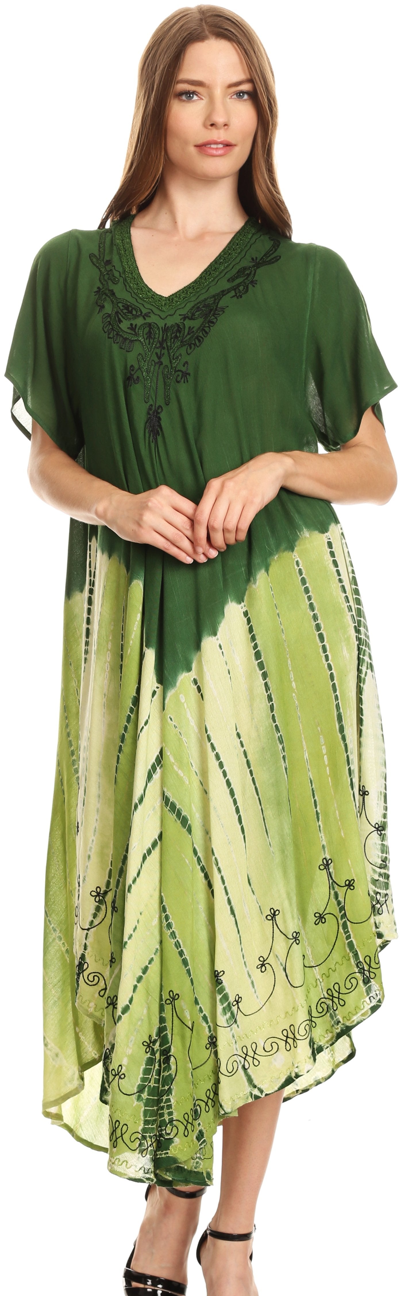 Woman wearing a green and white dress with a patterned design.