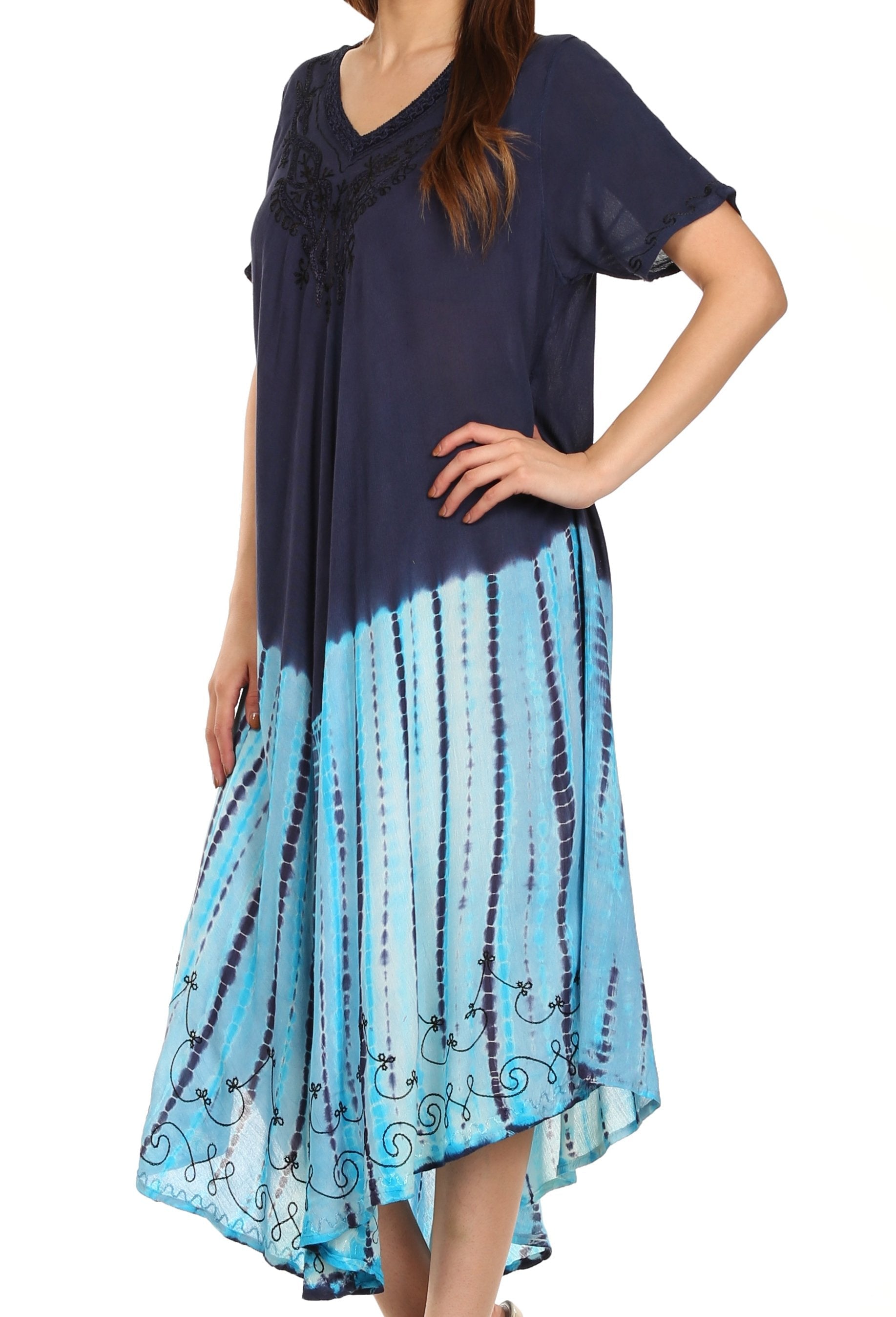 Woman wearing a navy top and blue tie-dye skirt on a white background