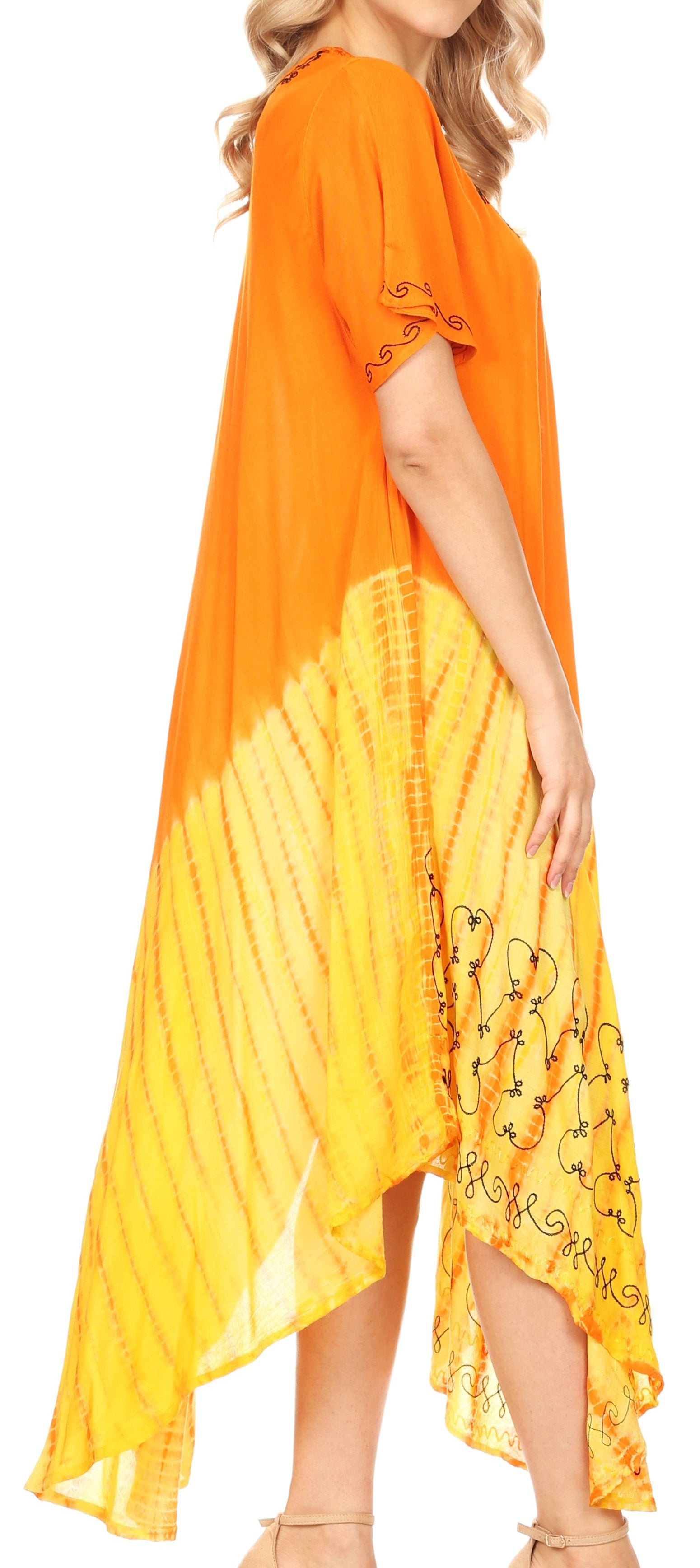 Woman wearing an orange and yellow dress with floral patterns on a white background