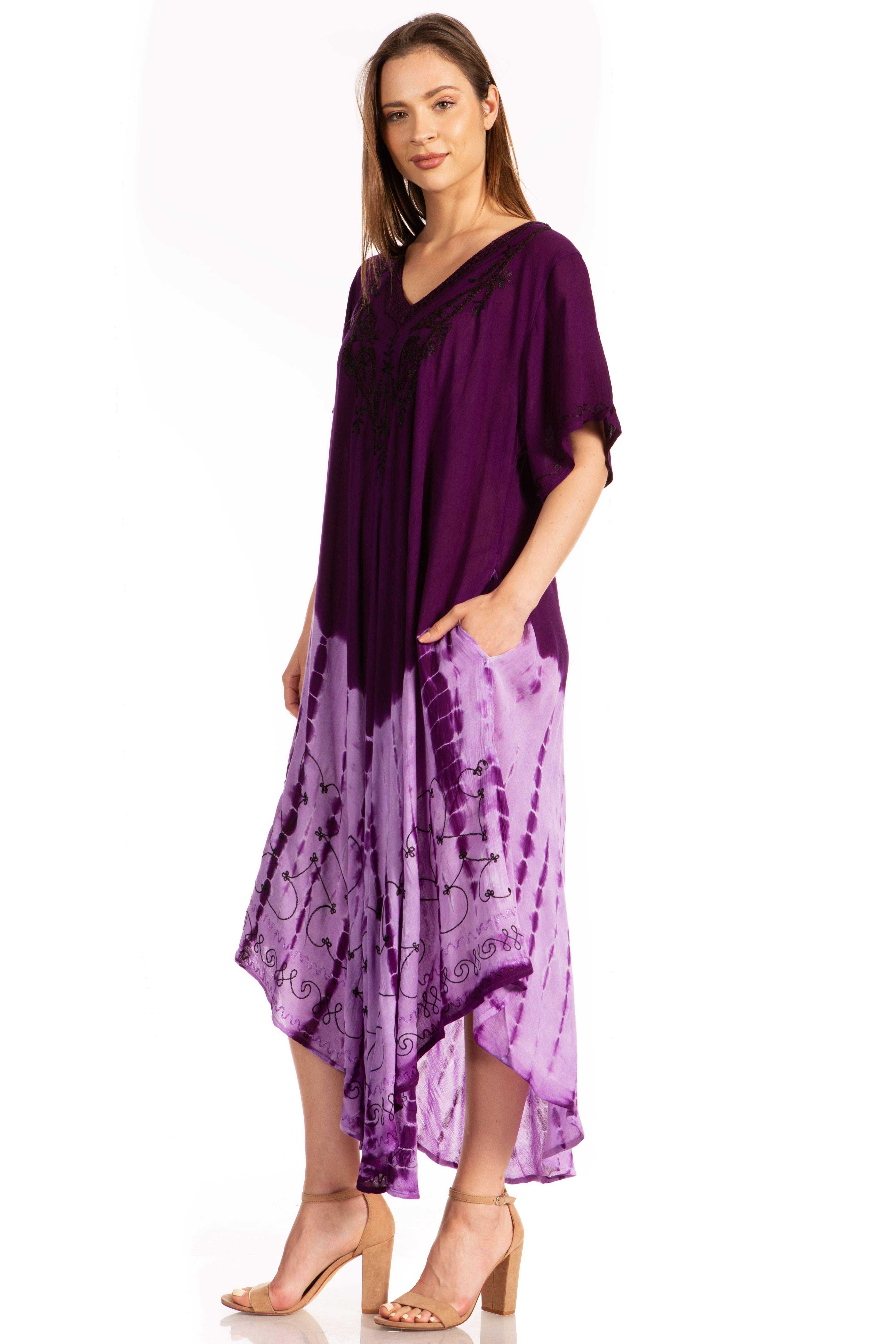 Woman wearing a purple tie-dye dress with a plain background