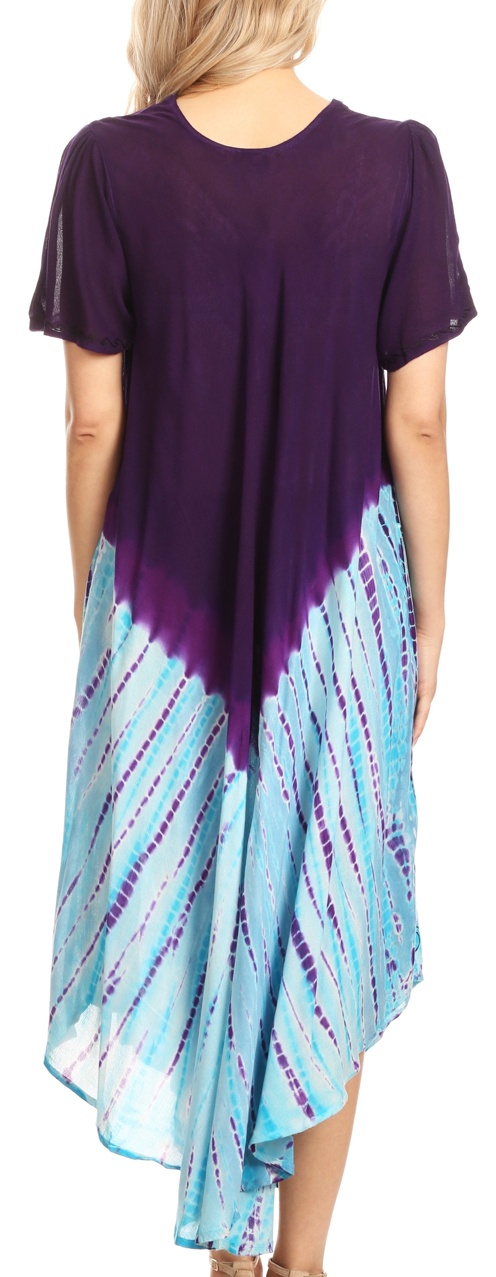 Woman wearing a purple top and blue tie-dye skirt on a white background