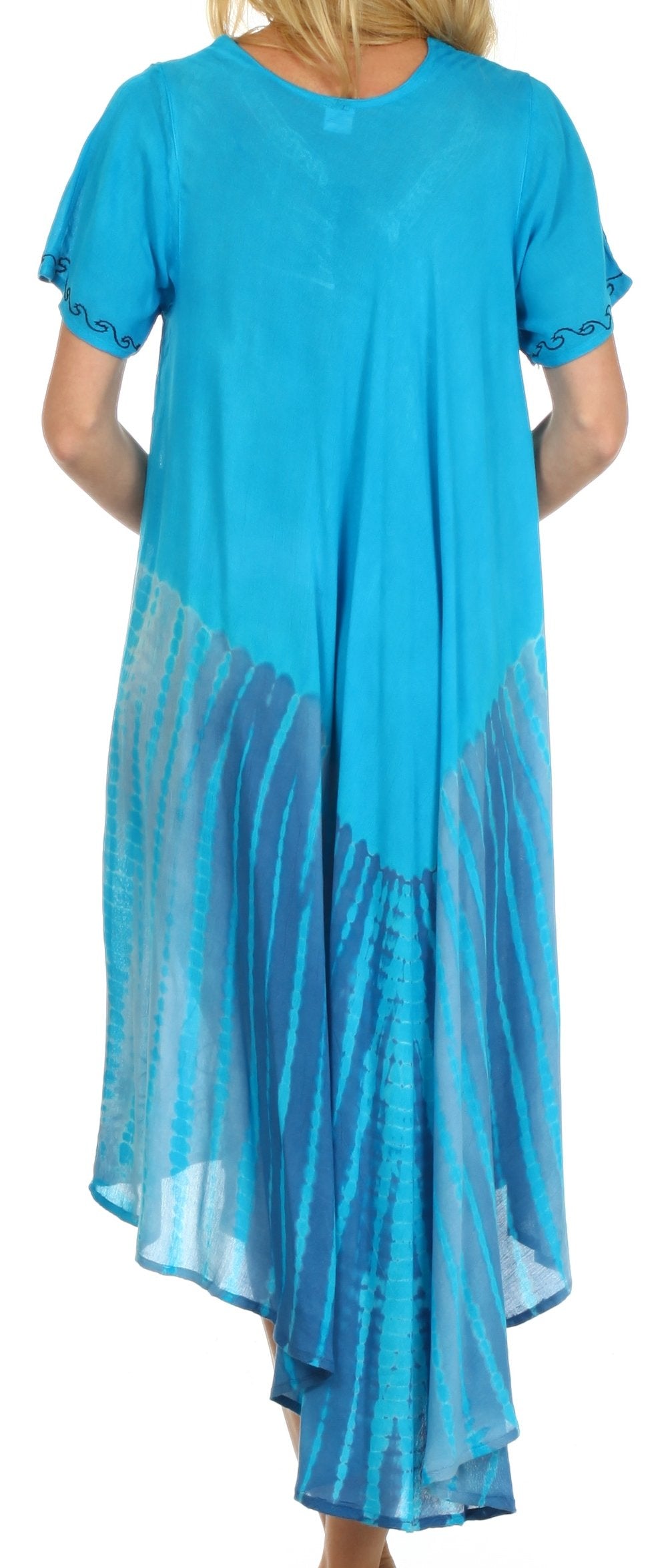 Woman wearing a blue dress with sheer panels on a white background