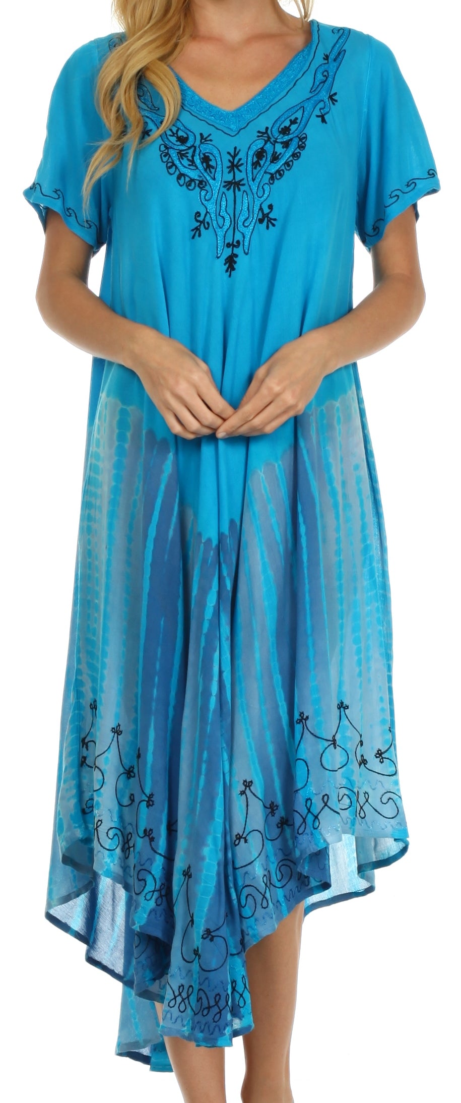 Woman wearing a blue dress with embroidery details on a plain background