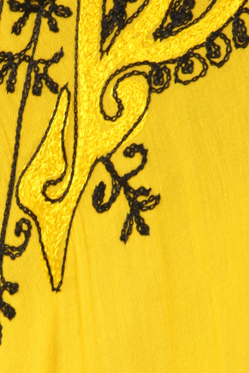 Black embroidered design on a yellow fabric