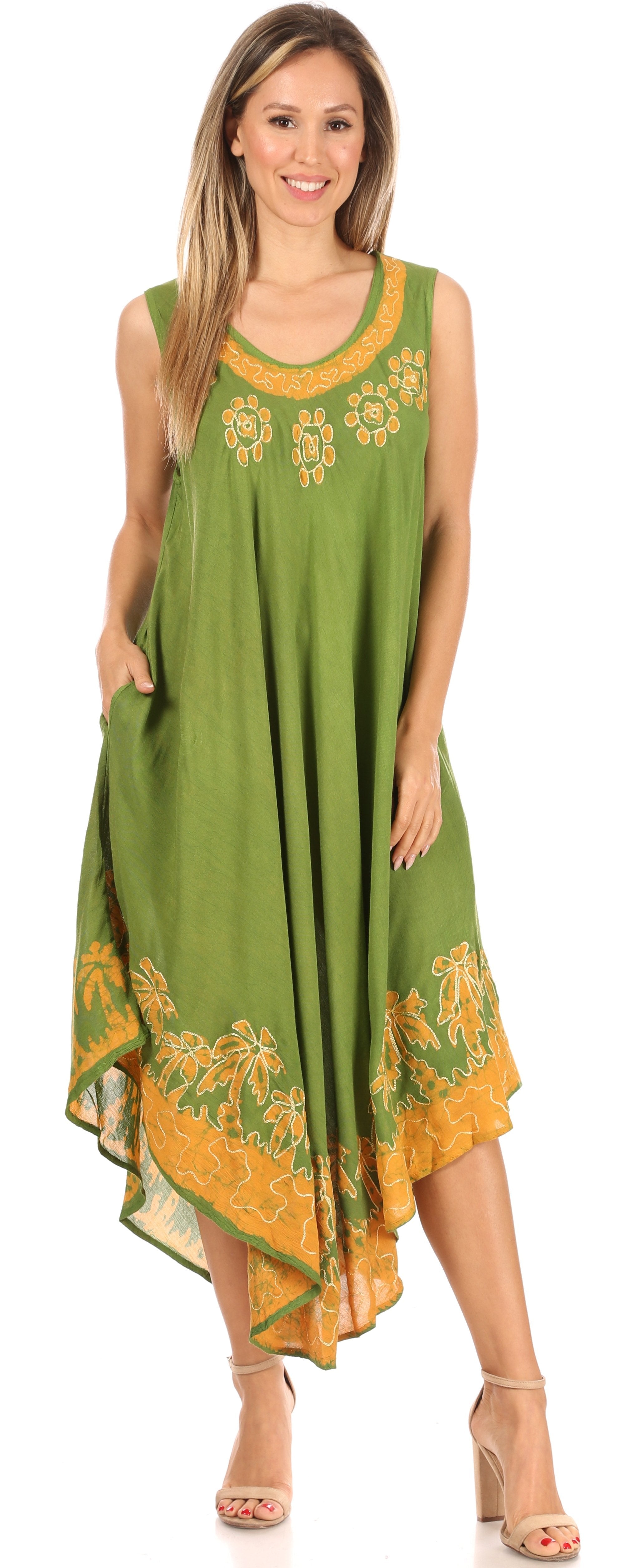 Woman wearing a green and orange dress with floral patterns on a white background