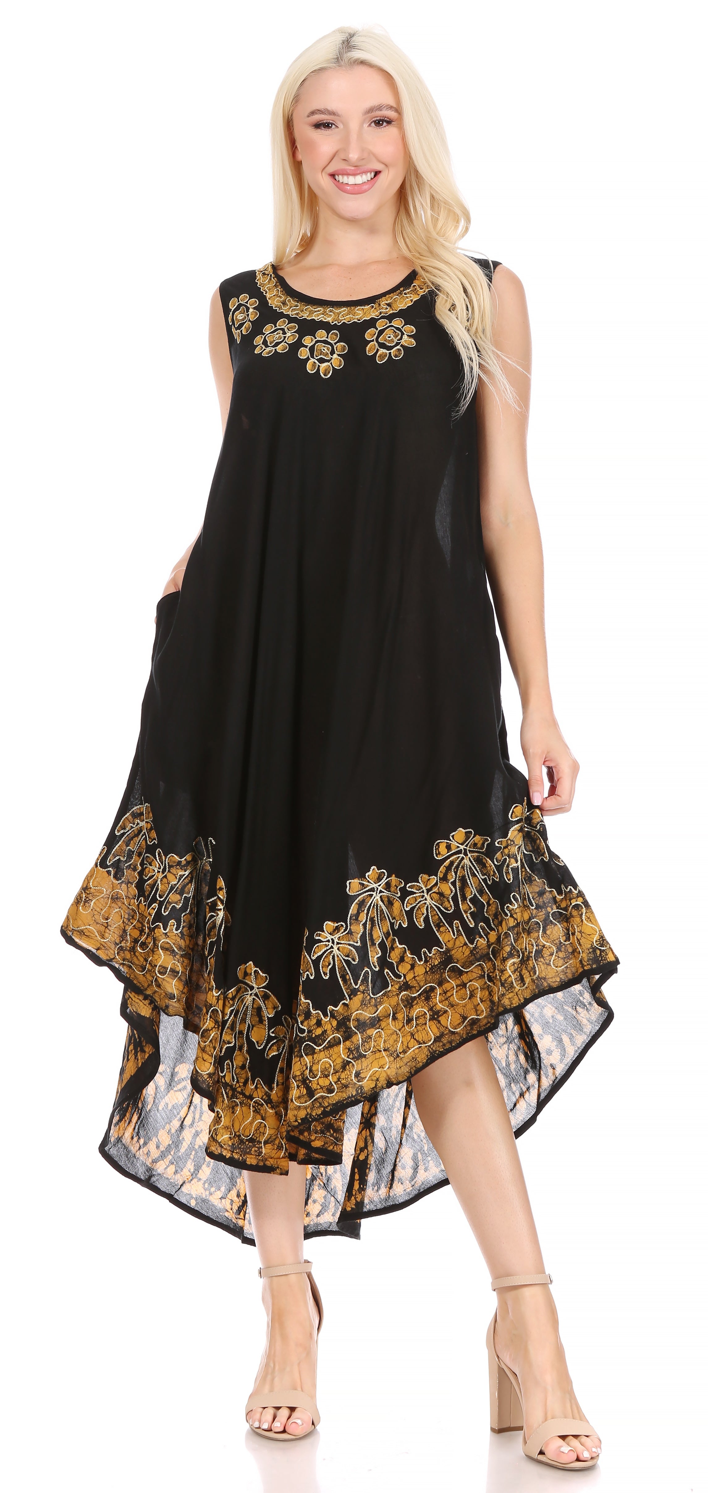 Woman wearing a black dress with gold floral patterns on a white background